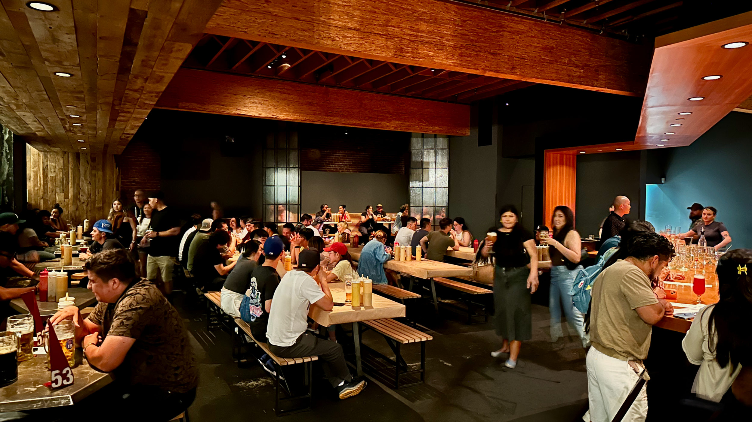 Inside of DTLA location bar with people standing and sitting