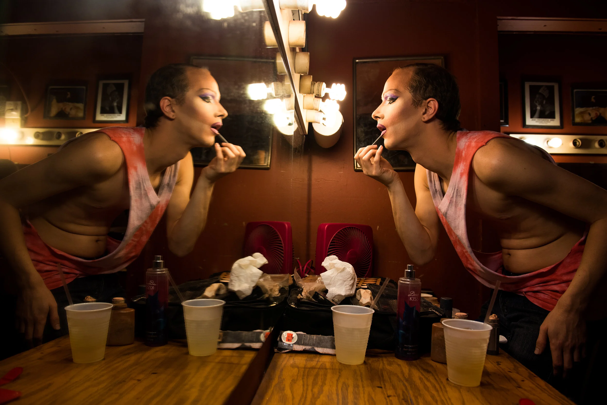 Koedam leans towards the mirror to apply thick layers of a frosty pink lipstick. He said that the more dramatic the makeup, the better it looks on stage. “Think of Rachel as a seductive super villain by night and a fashion model by day,” Koedam said. “And also a video hoe.”