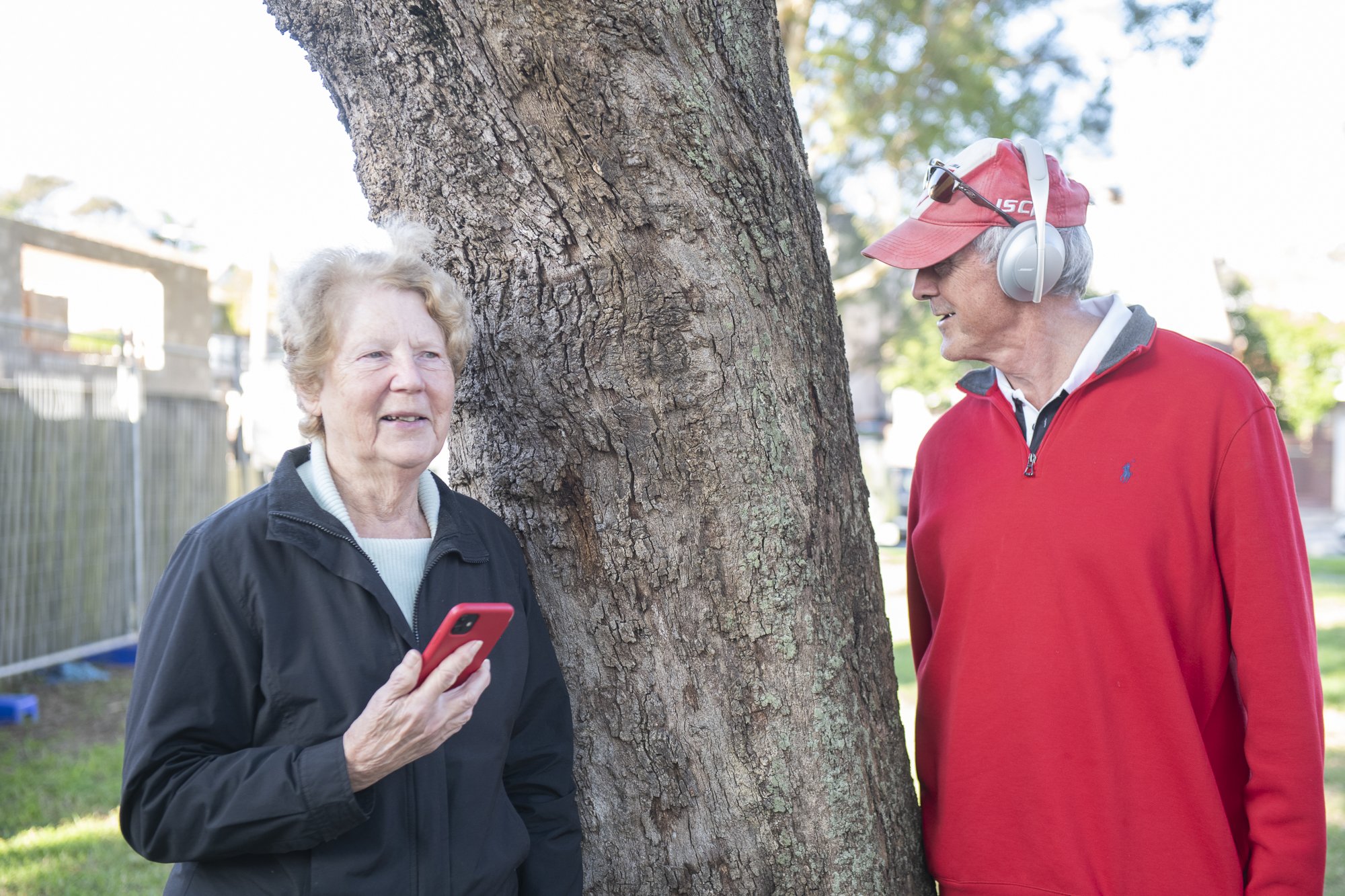 A couple listening by tree.jpeg