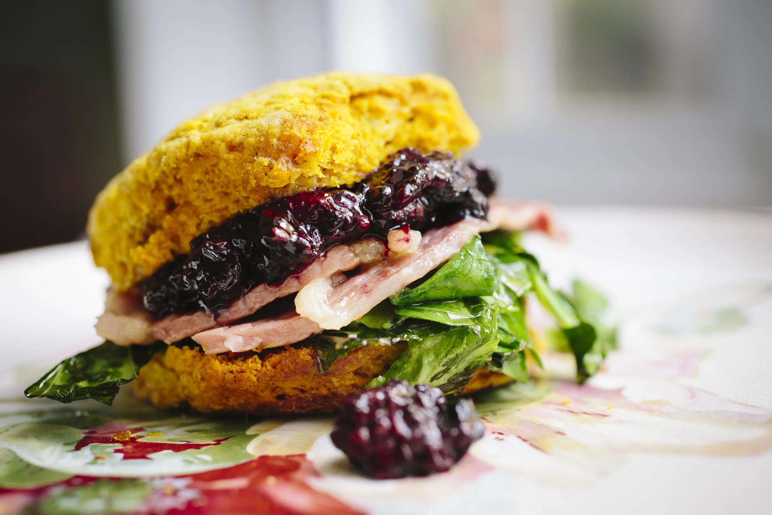 PUMPKIN BISCUIT WITH HAM + GREENS + BLACKBERRY BALSAMIC SAUCE