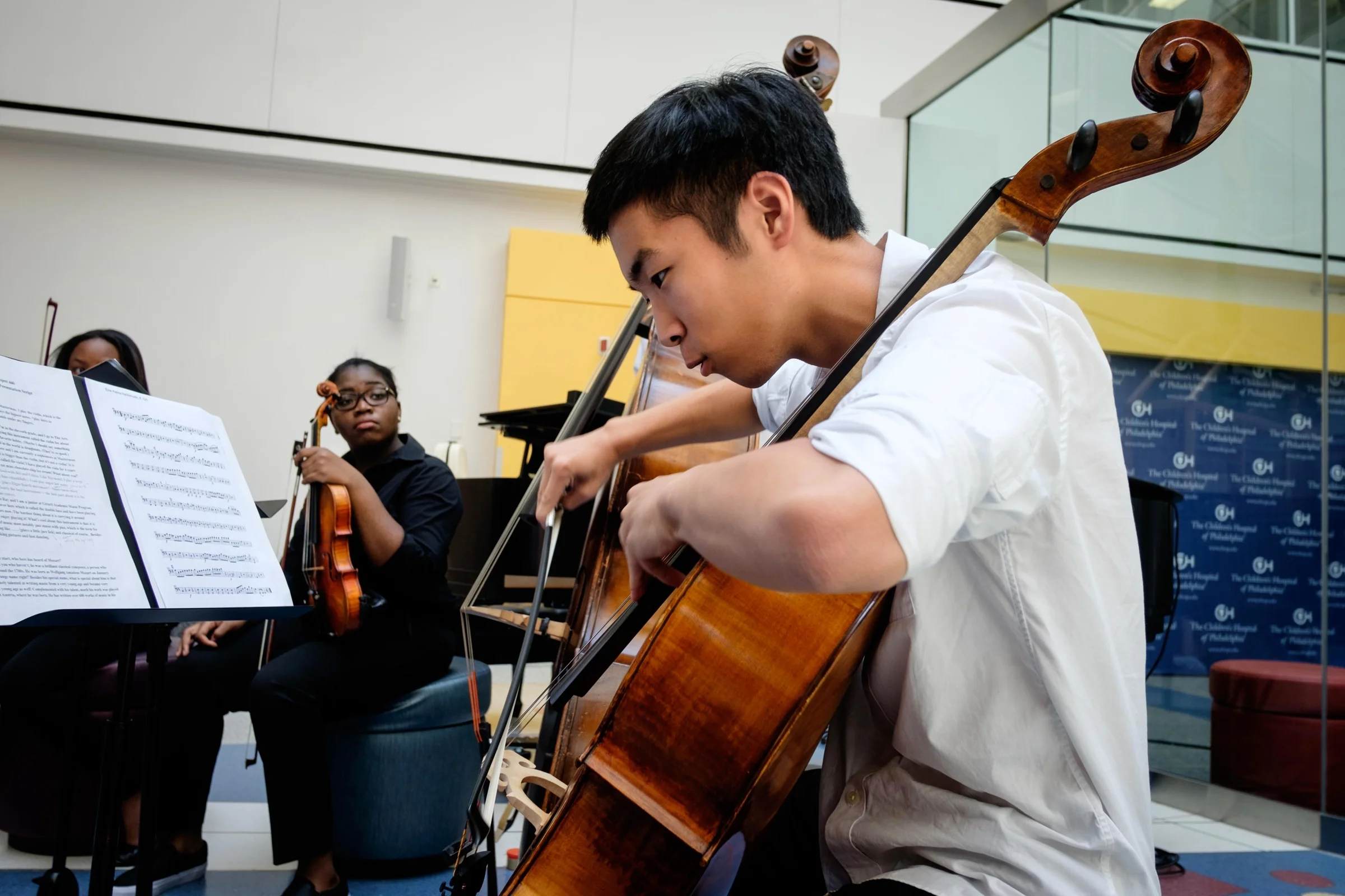 Nathan Kim demonstrates the distinct sound of the cello during an interactive performance at Children's Hospital of Philadelphia.