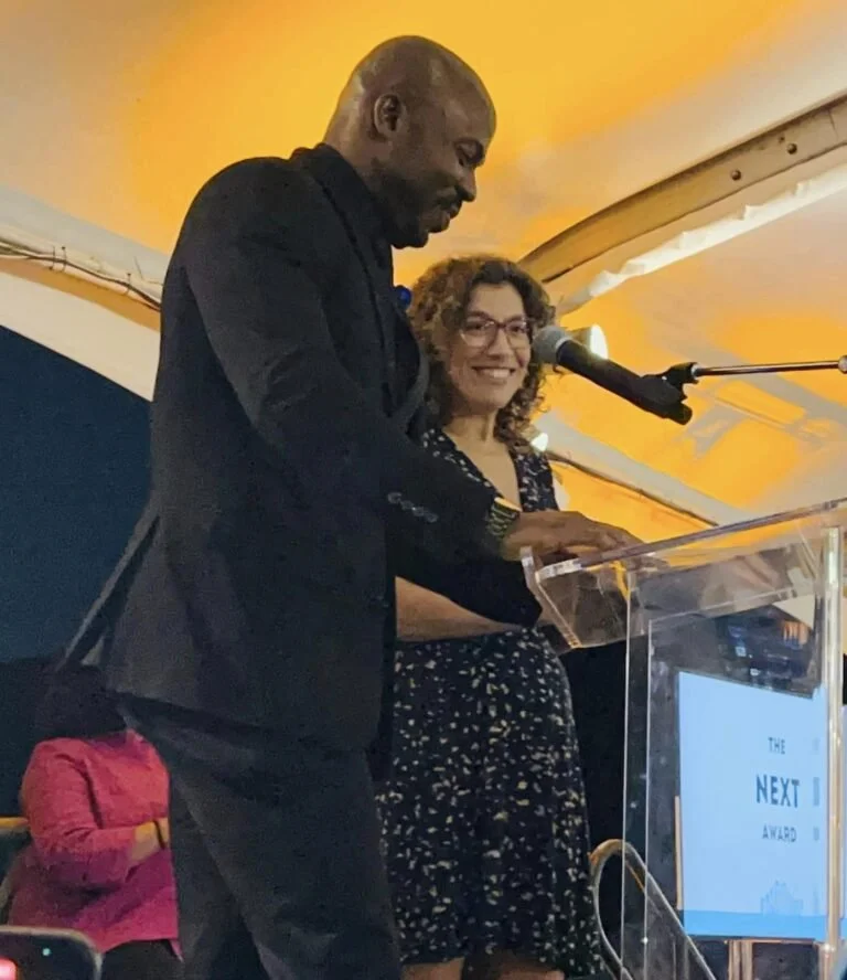 Joseph Conyers and executive director Rebecca Bolden accept the inaugural Next Award