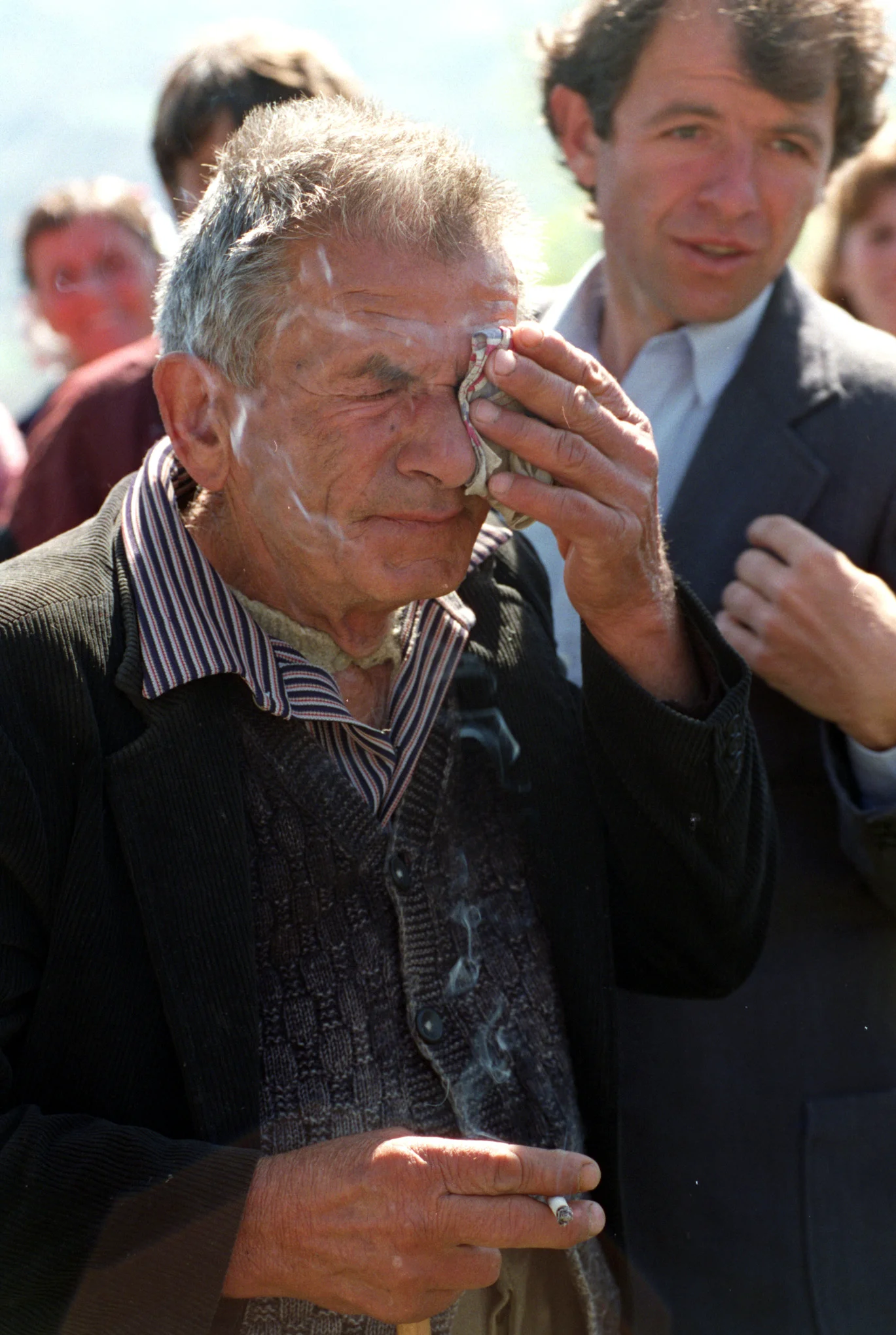 Iftijime Hazizi, 70, overcome with emotion, as the bell of St. Martin's church is rung, signaling the beginning of the first Orthodox service in 29 years in Jeronisht. ©Gail Fisher Los Angeles Times