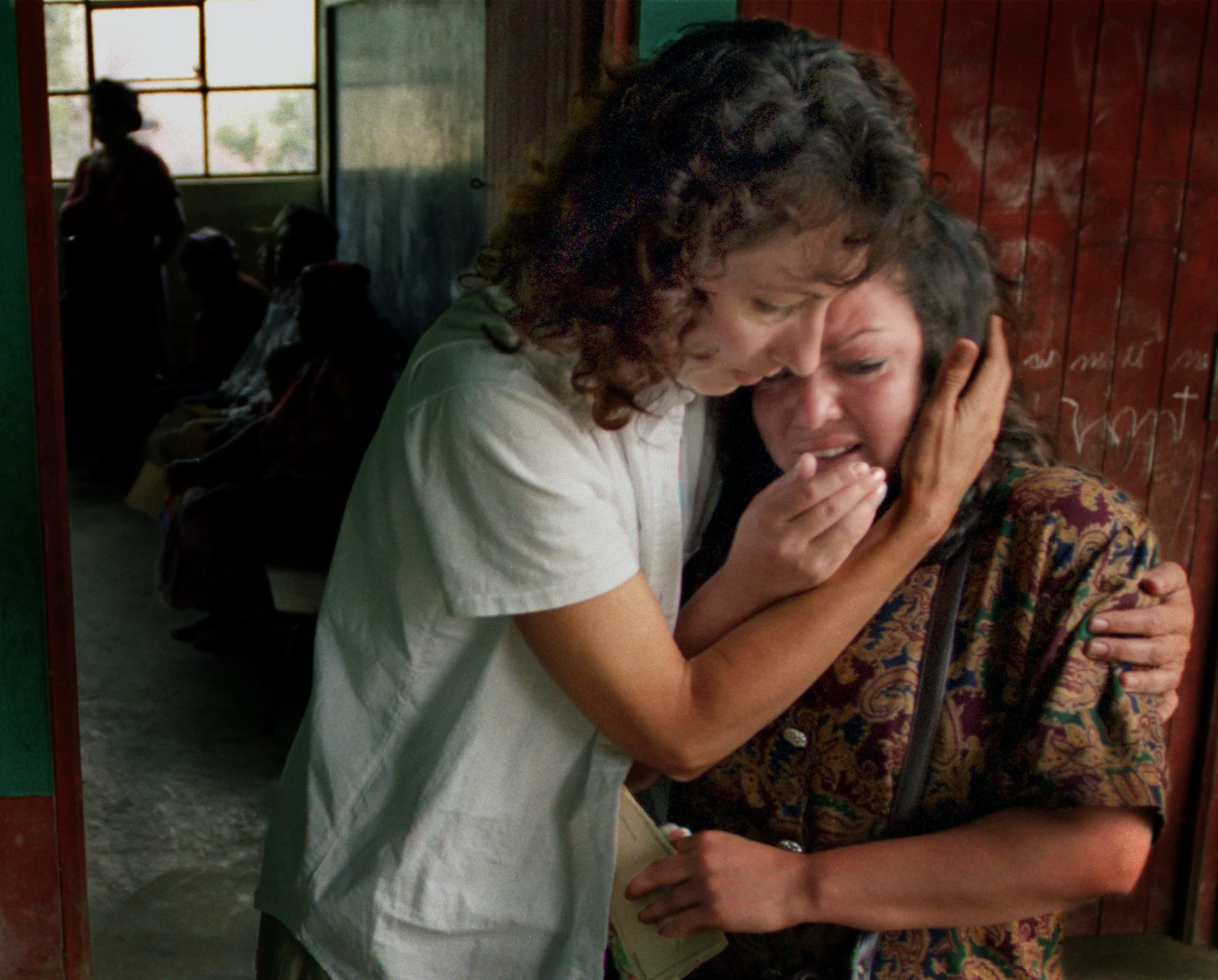 Leslie Baer, founder of Xela Aid, comforts Irna Lepe who has just been told that her two-year-old daughter, Diana, has a total retinal detachment in one eye, complicated by an infection which likely came from a farm animal, and will never see out the eye. ©Gail Fisher Los Angeles Times