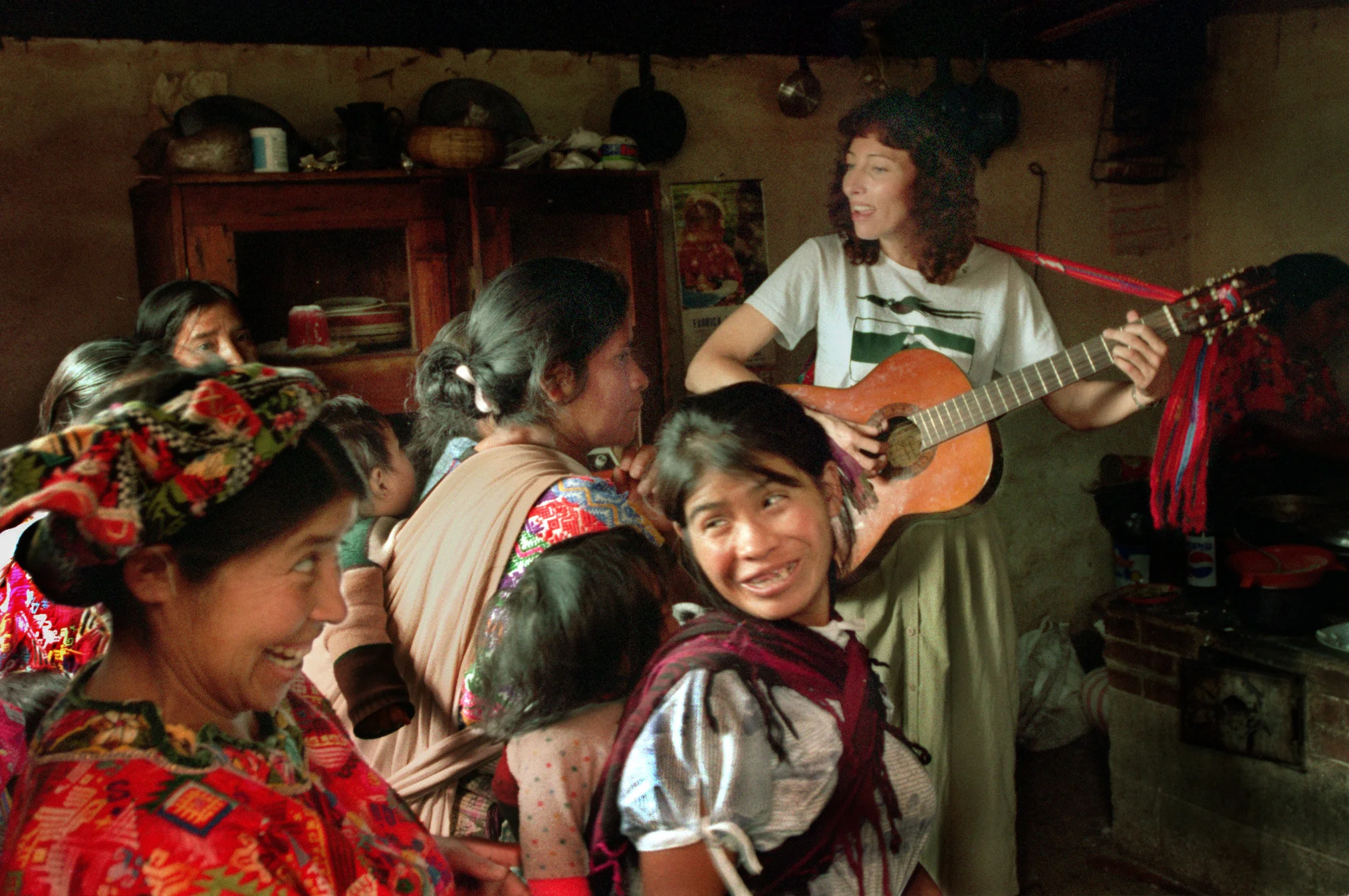 Baer, right with a group of the women villagers in San Martin Chiquito, enjoys interacting with music and songs and continues to work on the native language which led her to Guatemala several years ago before she founded Xela Aid. ©Gail Fisher Los Angeles Times
