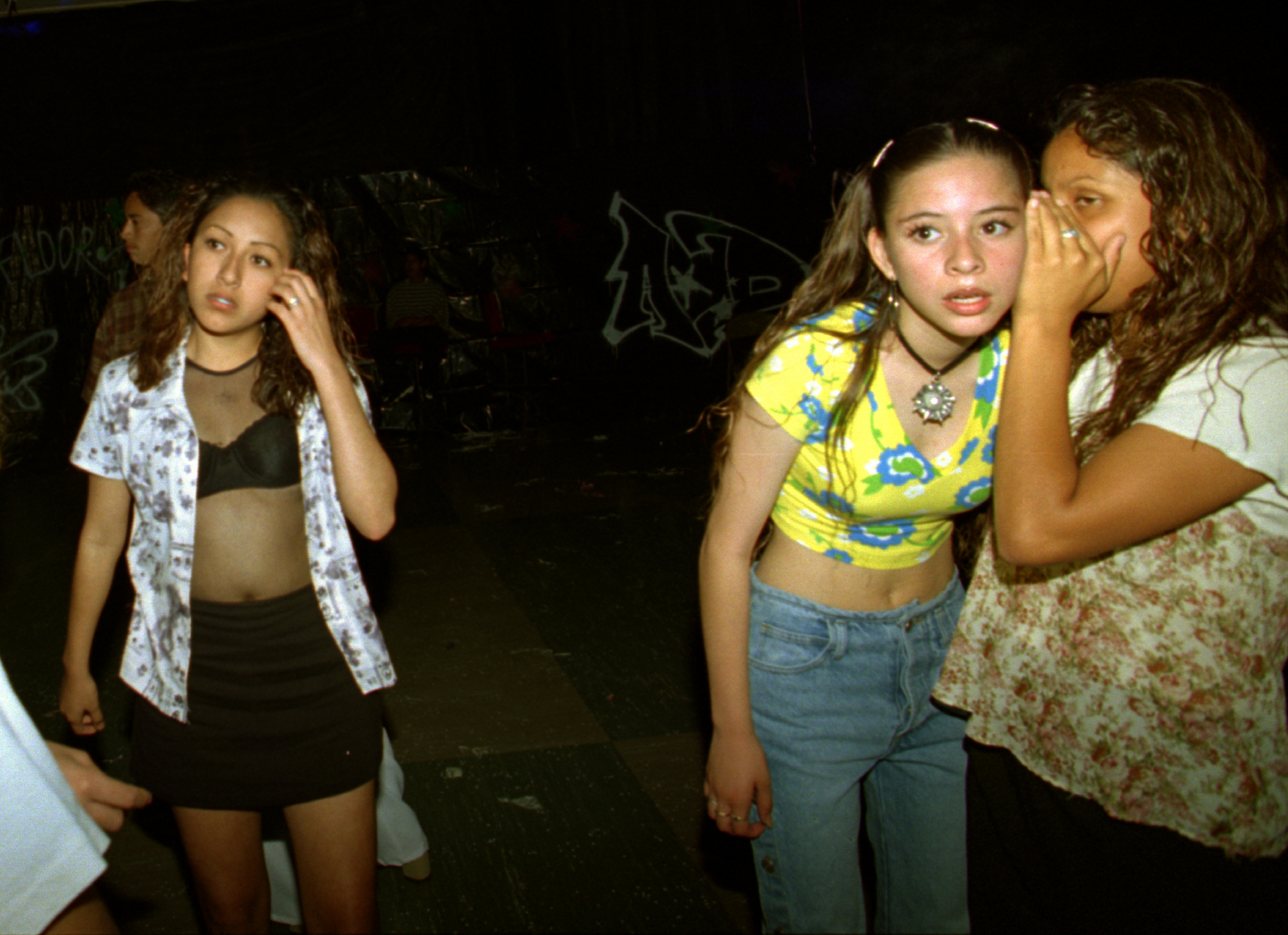 Left, Alicia who joined a gang at the age of 11, but has left that life behind, spends an evening out with friends at a Mecha dance at Tustin High School where she is a freshman. ©Gail Fisher Los Angeles Times 