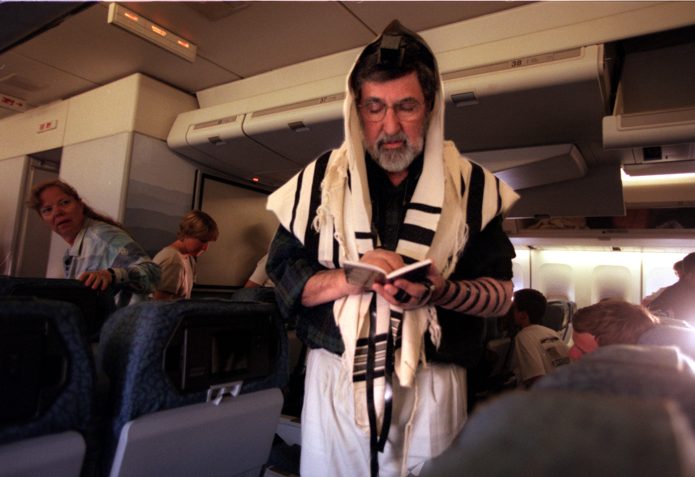  Rabbi Bernard King prays every morning at daybreak using the Tefillin, (transcriptionsfrom the text and quotations from the books of Exodus and Deuteronomy). During the flight to the Holy Land was no exception. As the plane refueled in Chicago, the 