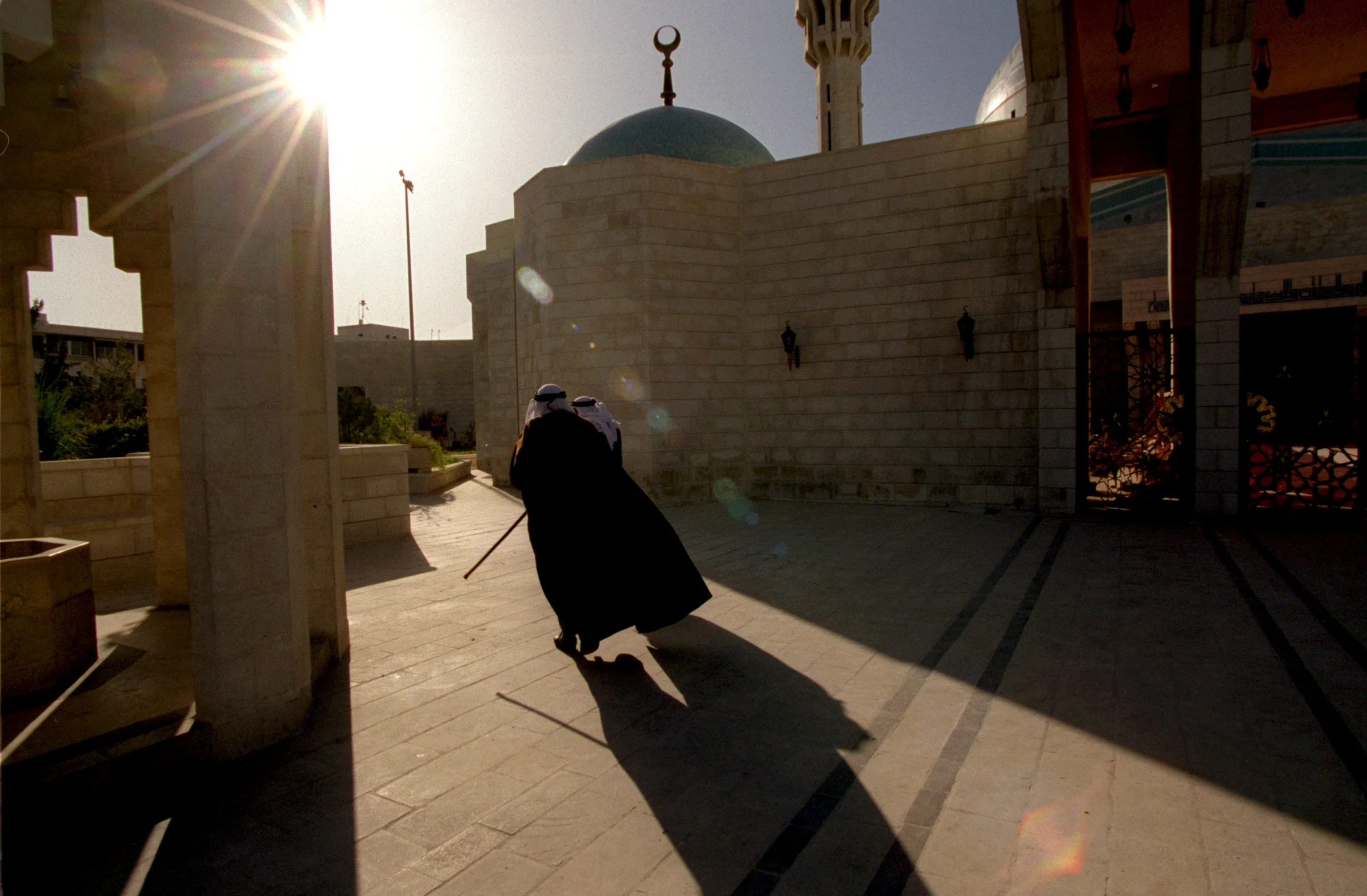 Muslims make their way into King Abdullah's Mosque in Amman, Jordan, for Friday prayers. The Interfaith group traveled to Christian, Jewish and Muslim sites during their pilgrimage. ©Gail Fisher Los Angeles Times