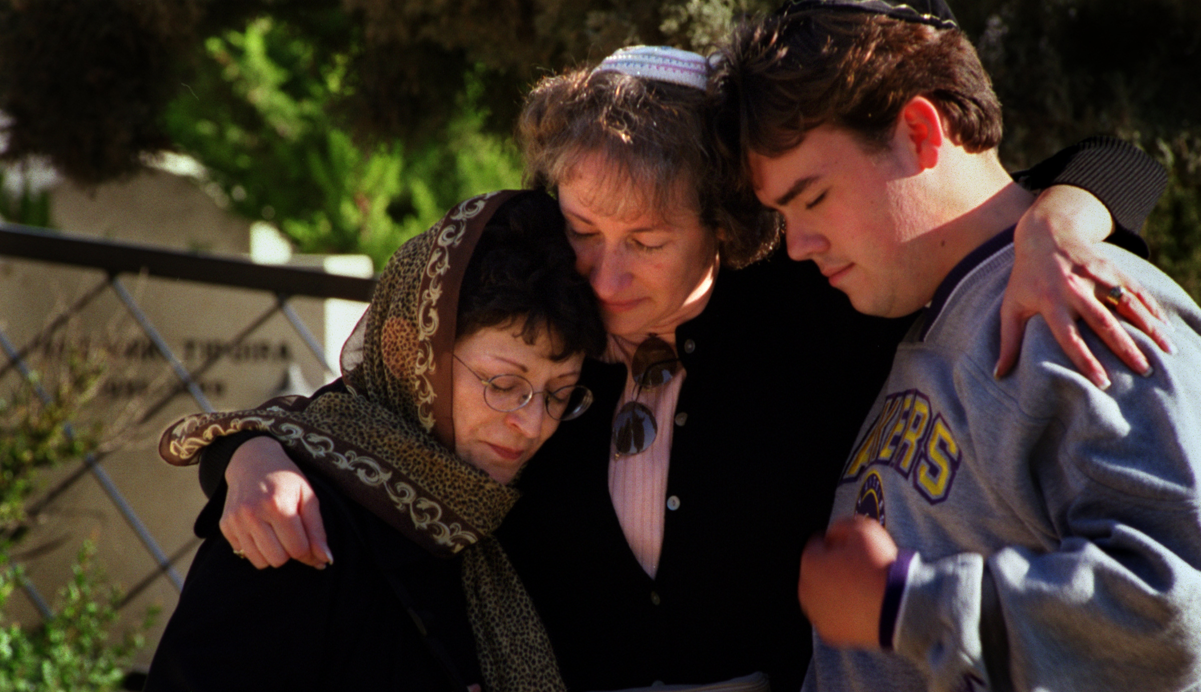  Left, Susan Smith, Barbara King, and Andrew Albers mourn atcemetery in Zefat where several children of Ma'Alot were buried after they lost their lives in a terrorist bombing during the conflict. Twenty-five years earlier Rabi Bernard King visited th