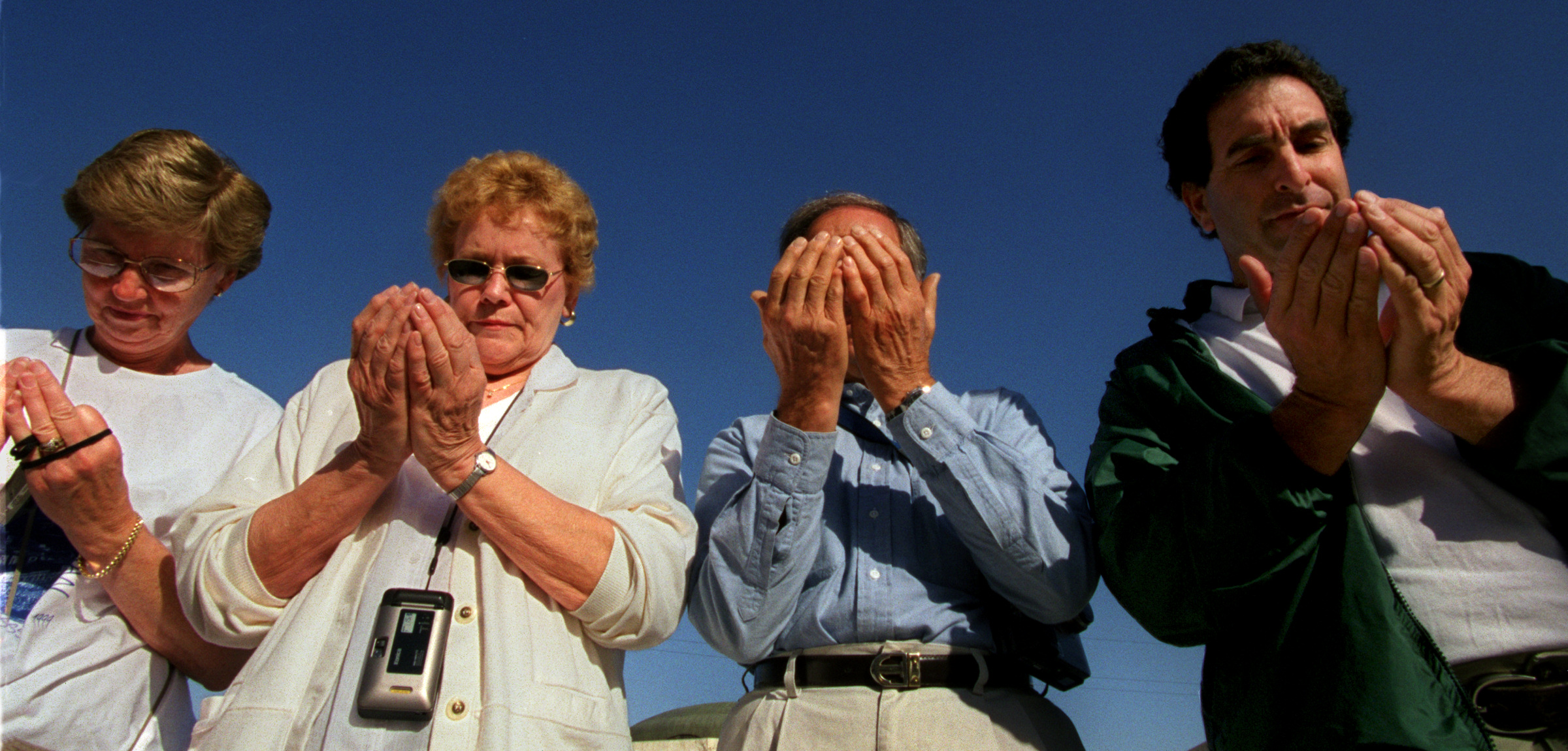 Left, Karen Bisel, Jean Simon, Hal Garner and William Shane, pray in the Islam tradition as Muslim leader Haithan Bundakji leads prayer in Arabic outside King Abdullah's Mosque in Amman, Jordan. ©Gail Fisher Los Angeles Times