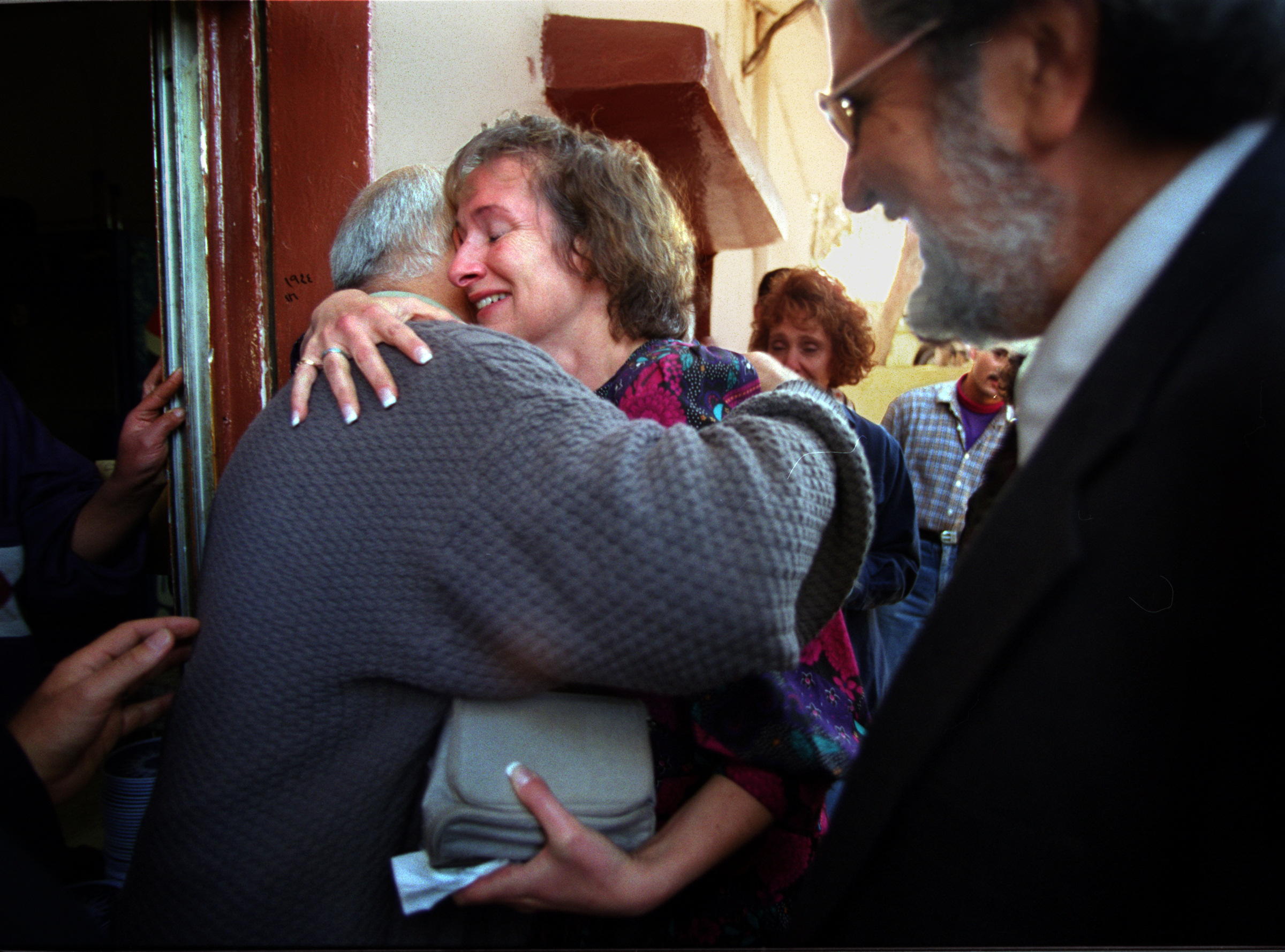  At a restaurant in Jerash,&nbsp; owner Ishmael Shuqqir, left, hugs Barbara King after confrontation resolved with Rabi King, right. Owner was upset with Muslim leader whom had brought Jews into his restaurant. Some of the Jews, including the Rabi co