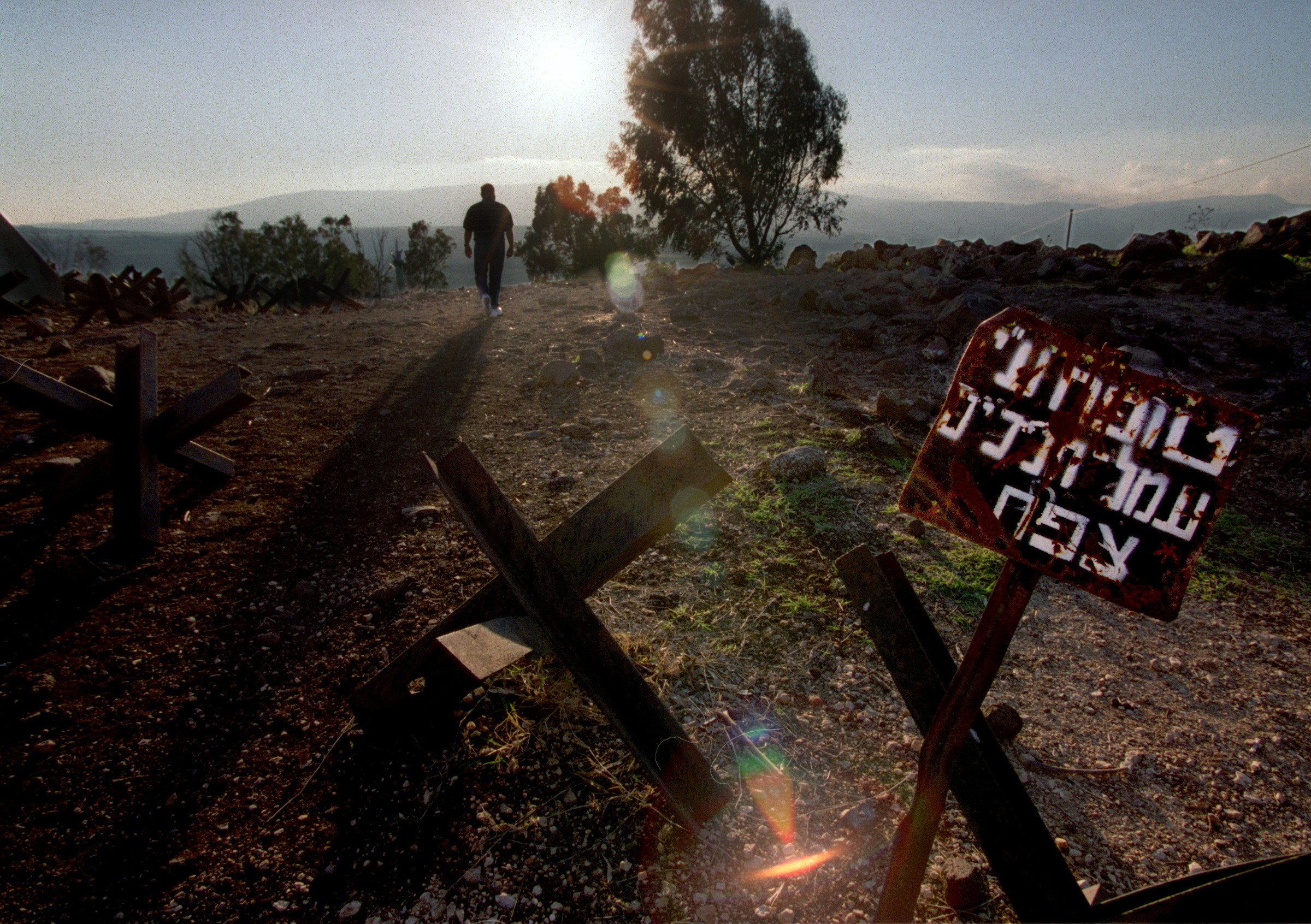  Haithan Bundakji ascends to a memorial in Golan Heights, the stronghold of the Syrians until 1967. Nearly all of the landscape bordering the road throughout this area is lined with barb wire and thousands of land mine markings.&nbsp;©Gail Fisher Los