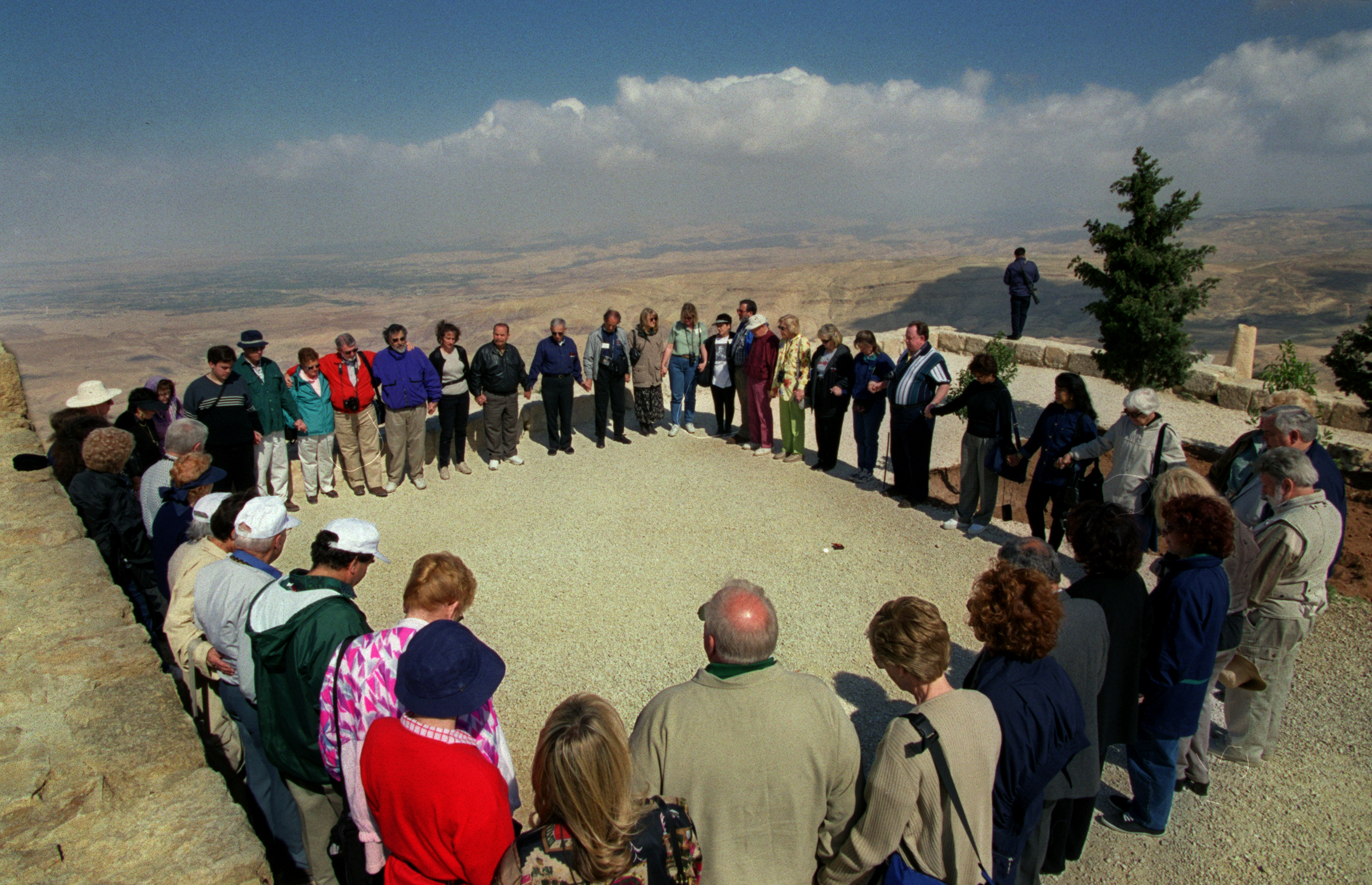 On the top of Mount Nebo, in present day Jordan, Rabi Bernard King leads a Interfaith group prayer in Hebrew over looking the Jordan Valley and the Dead Sea. Historians believe Moses' tomb lies in this region.&nbsp;©Gail Fisher Los Angeles Times 