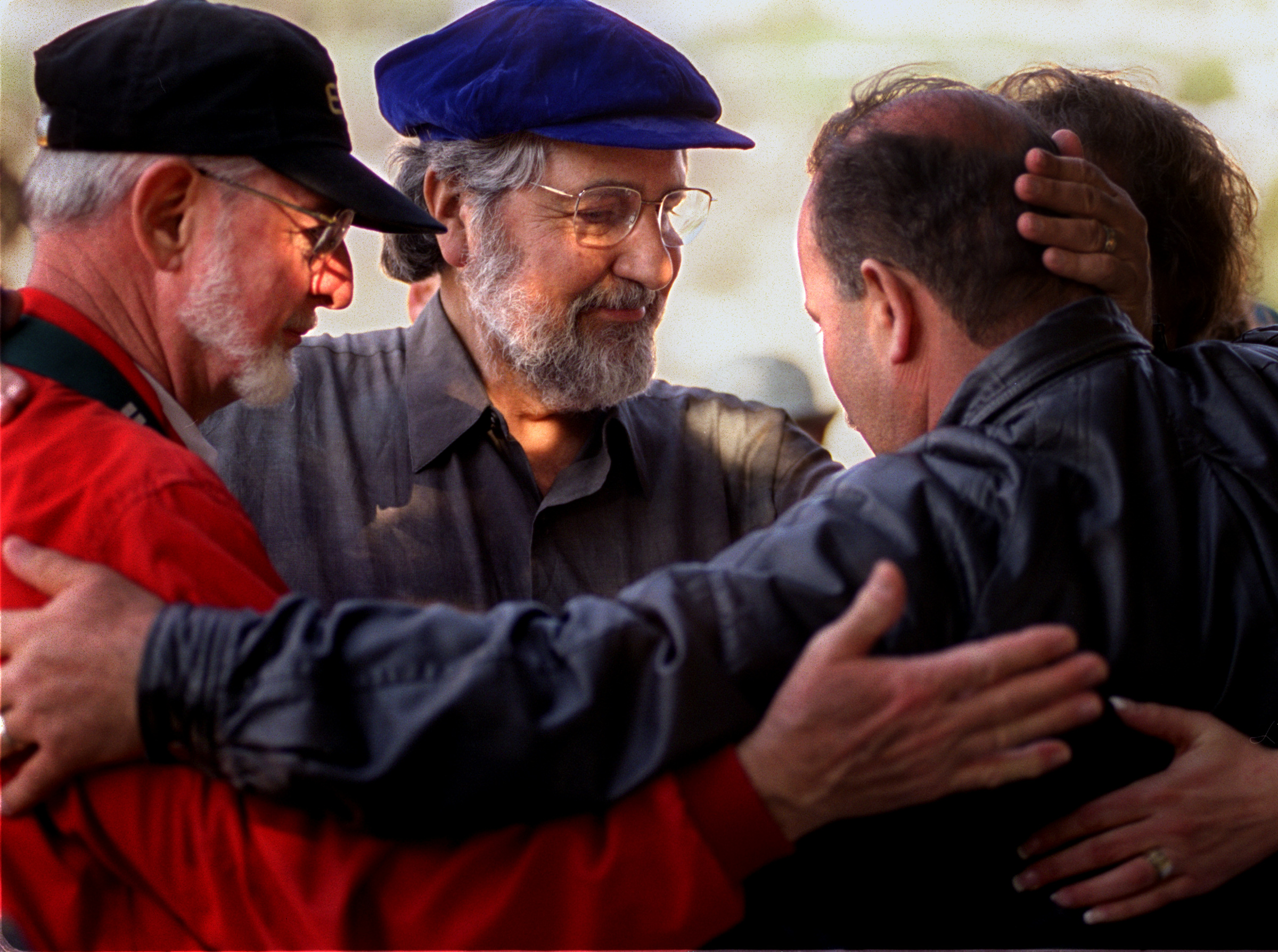 Left, leaders Rev. Robert Shepard, Rabbi Bernard King and Haithan Bundakji show their support for each other atcemetery in Zefat. Several children of Ma'Alot were buried after they lost their lives in a terrorist bombing during the conflict. Twenty-five years earlier Rabi Bernie King had visited the grave site and returned home to Orange County naming his synagogue after Ma' Alot. ©Gail Fisher Los Angeles Times