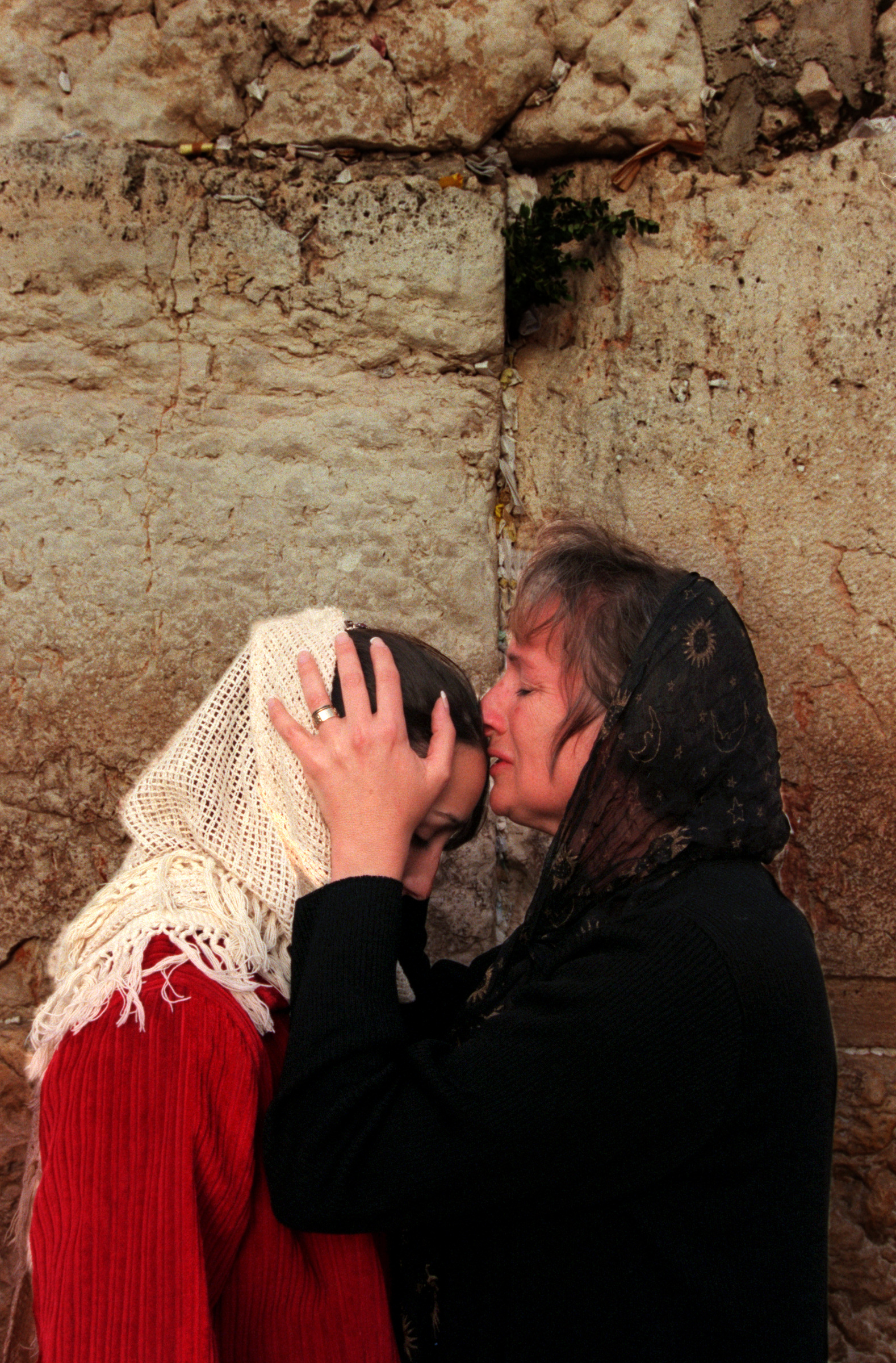 Left, Adeena King and her mother Barbara, over come with emotion, pray at the Western Wailing Wall, in Old City Jerusalem, one of the most Holy sites in Judaism. ©Gail Fisher Los Angeles Times