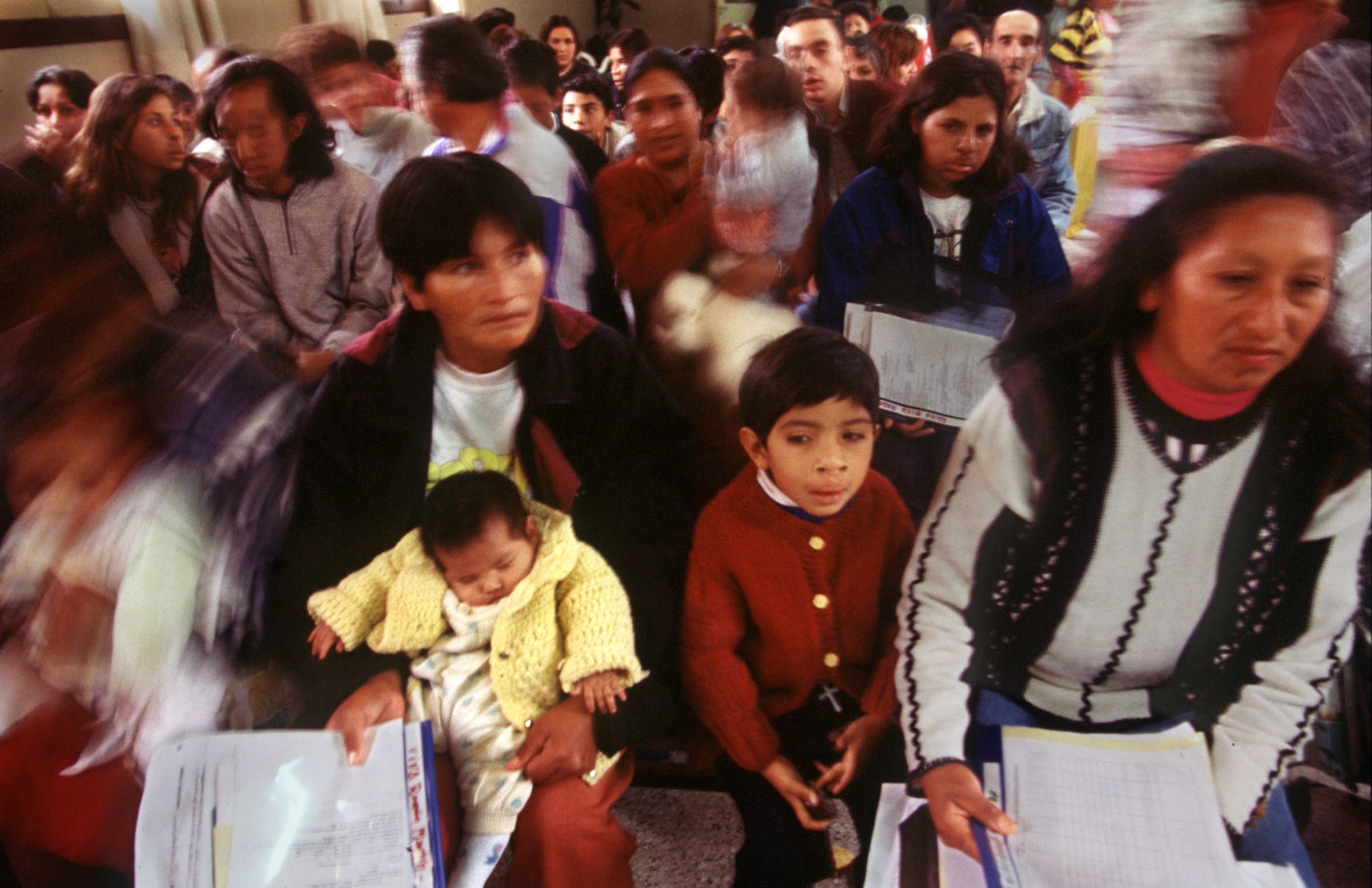 Two hundred people, mostly children, waiting to be evaluated by the international Rotaplast medical team, pack the clinic with their families. Those identified for surgery are assigned bed space in a nearby military barracks where they will stay the duration. The most difficult surgeries are scheduled first, to give doctors more time to deal with any complications. ©Gail Fisher for Los Angeles Times 