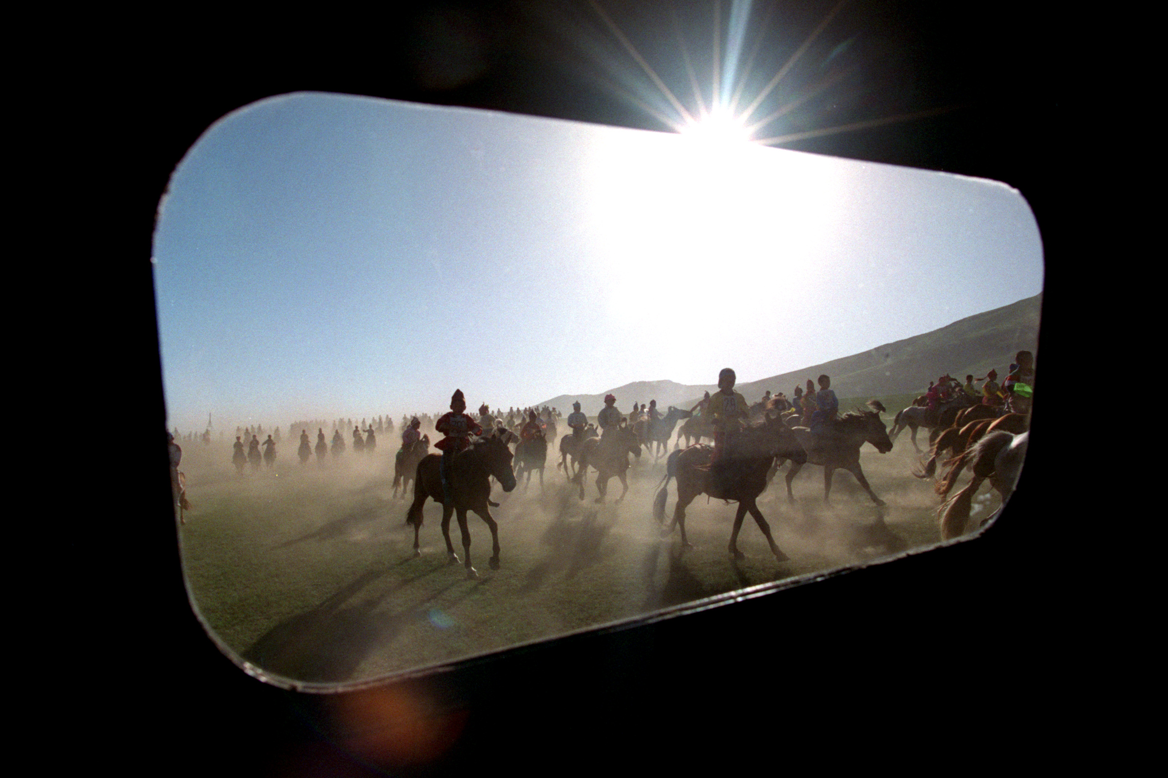 The doctors enjoy the experience of the traditional Naadam festival, and see it through various perspectives, sometimes through a window driving in a truck. ©Gail Fisher Los Angeles Times