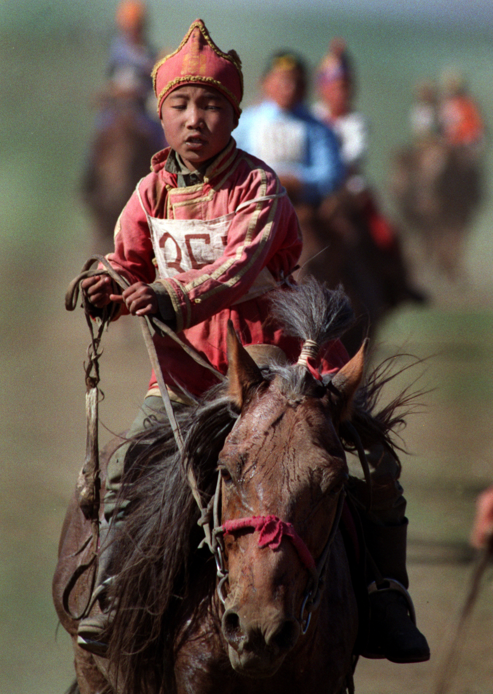 July's annual Naadam festival, celebrating Mongolia's independence from China in 1921, centers on traditions such as horseback riding. Contestants, ages 4 to 11, race over about 15 miles of open countryside. ©Gail Fisher Los Angeles Times