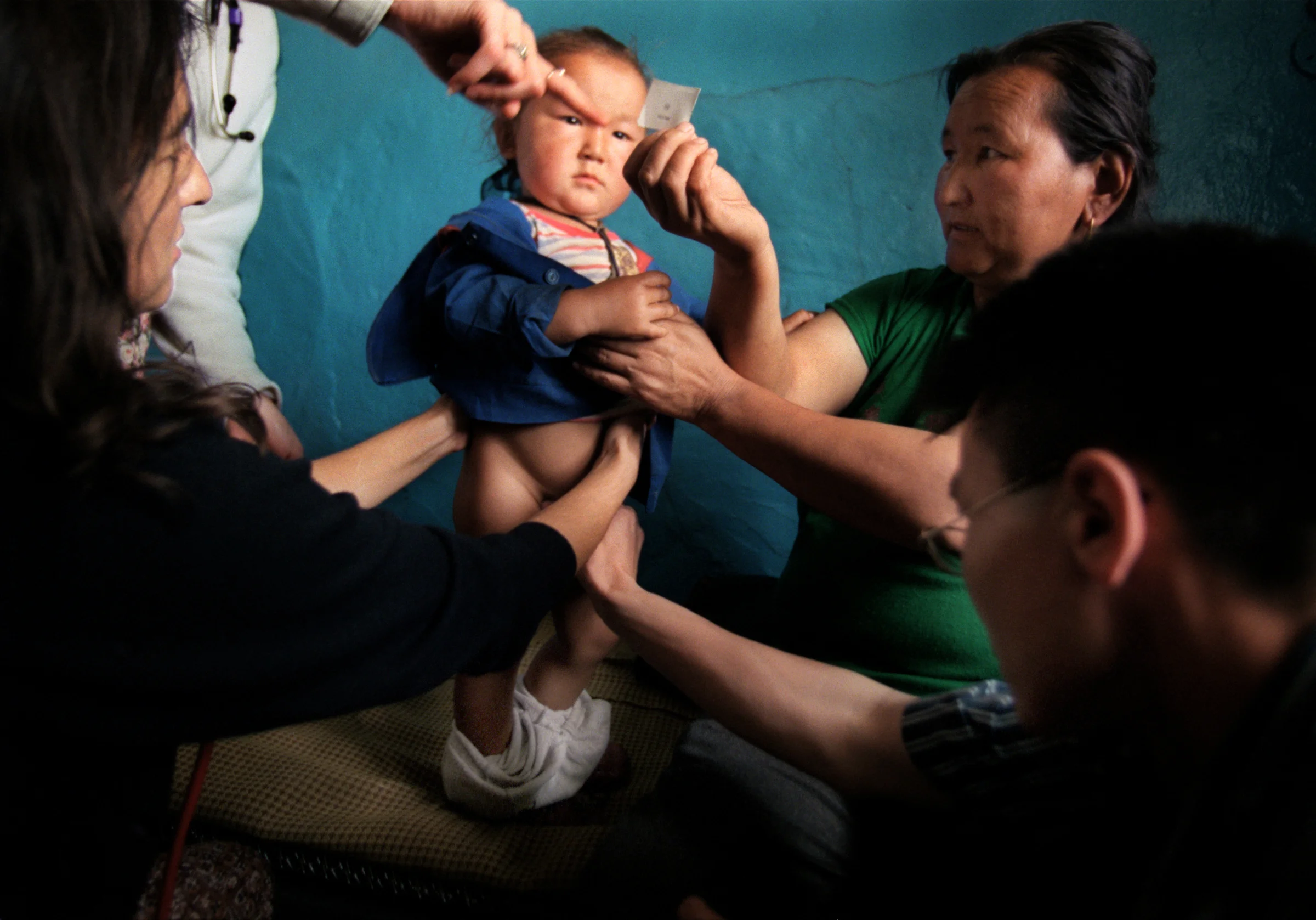 Tcerenchunt, 2, suffering from a hernia, gets the once-over after his mother, Chimedtceren, brought him to a clinic in Tu Aymog, a small village medical facility about 80 miles from Ulaan Baatar. Just over half the national population of 2.5 million, live in cities.The rest lead semi-nomadic lives in the countryside, living off herds of sheep, goats and cows. ©Gail Fisher/Los Angeles Times