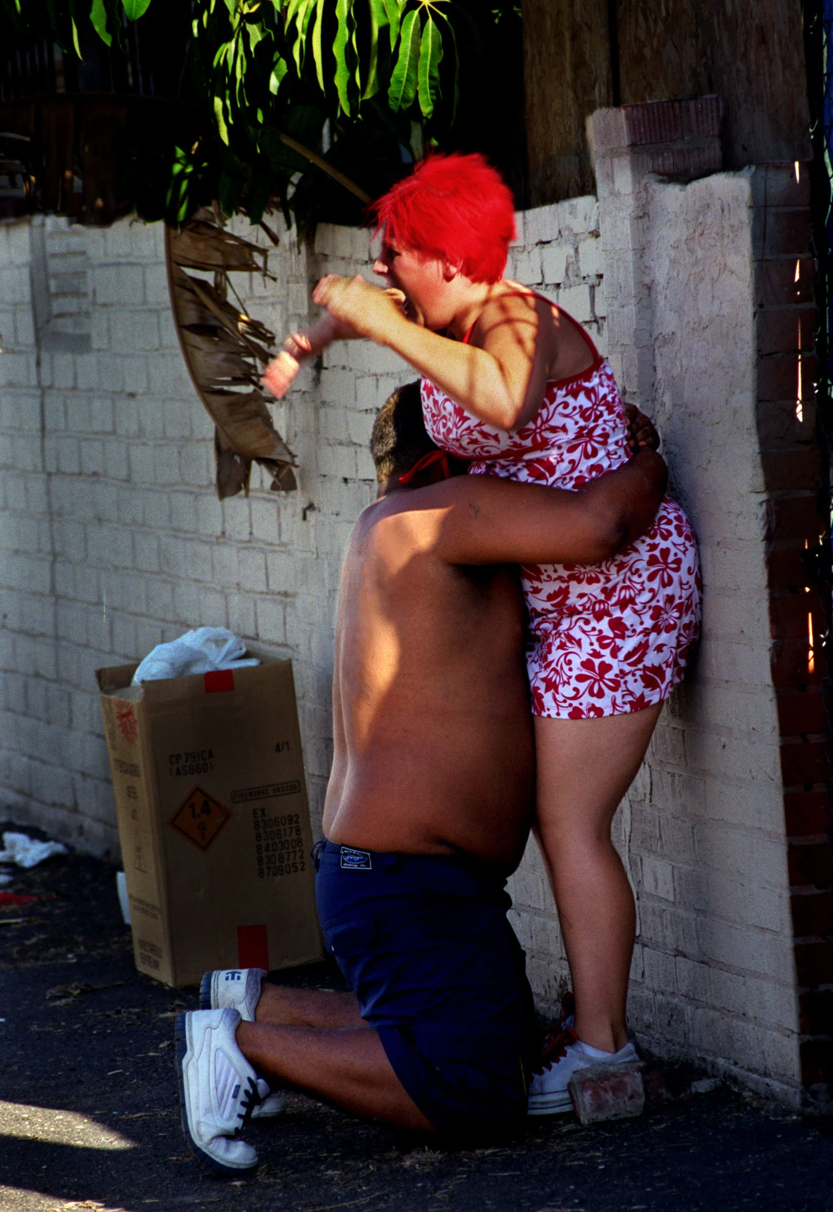The fight continues and Janea pounds on her husband Sam, but he refuses to let go. He falls to his knees crying and begging her to forgive him. The struggle continues as she tries to escape his grip. ©Gail Fisher Los Angeles Times 