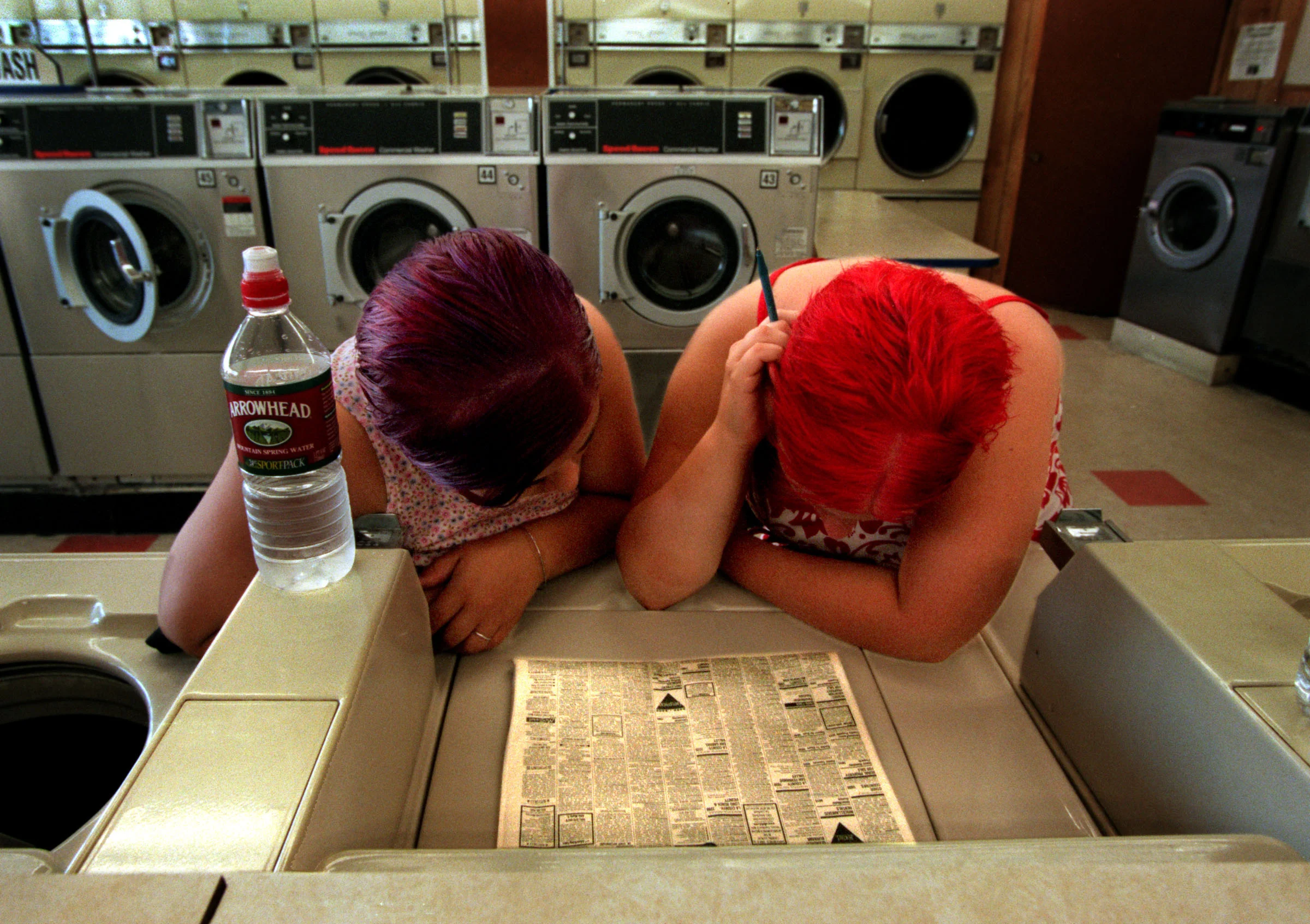Evicted from the Royal Knights Motel, Dianna and Janea search the classifieds for a place to rent. Their entire net worth amounts to $40 in food stamps. The solution: Pool their next welfare check. ©Gail Fisher Los Angeles Times 