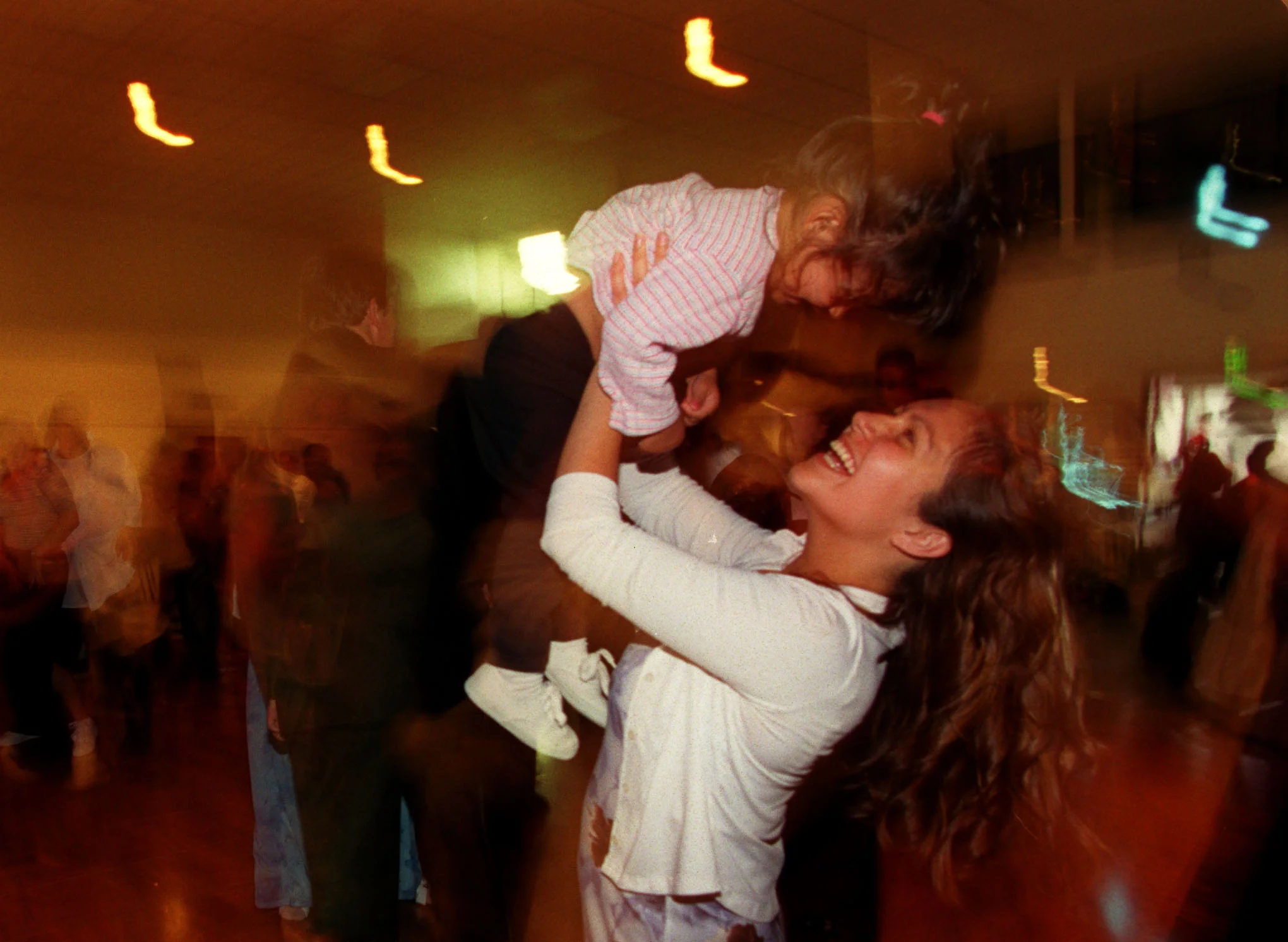 During the graduation festivities at Mariner's church, Monique Luna and daughter Lyla Molina, take a few spins on the dance floor. "I had never been to a prom. That was like my prom. I had my little girl. So it was more than just a graduation. She's my whole family. Everybody that needed to be there was there," says Monique. ©Gail Fisher Los Angeles Times 