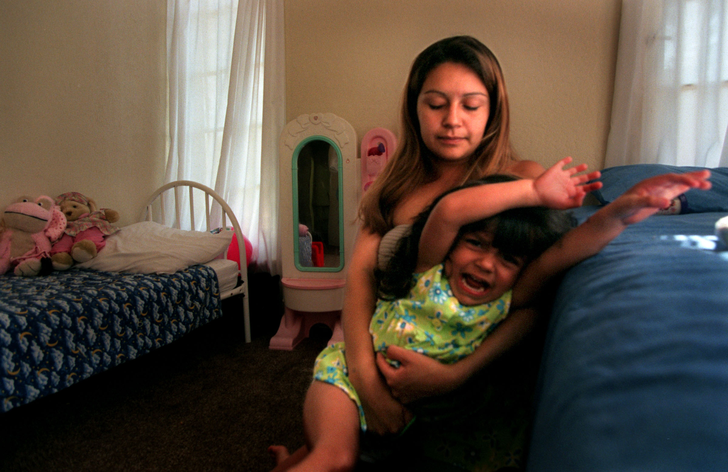 A single teen, working mother, Monique at times struggles with her three-year-old. "I can't force her to go to sleep. I can't hold her down and make her do it," Monique says. ©Gail Fisher Los Angeles Times 