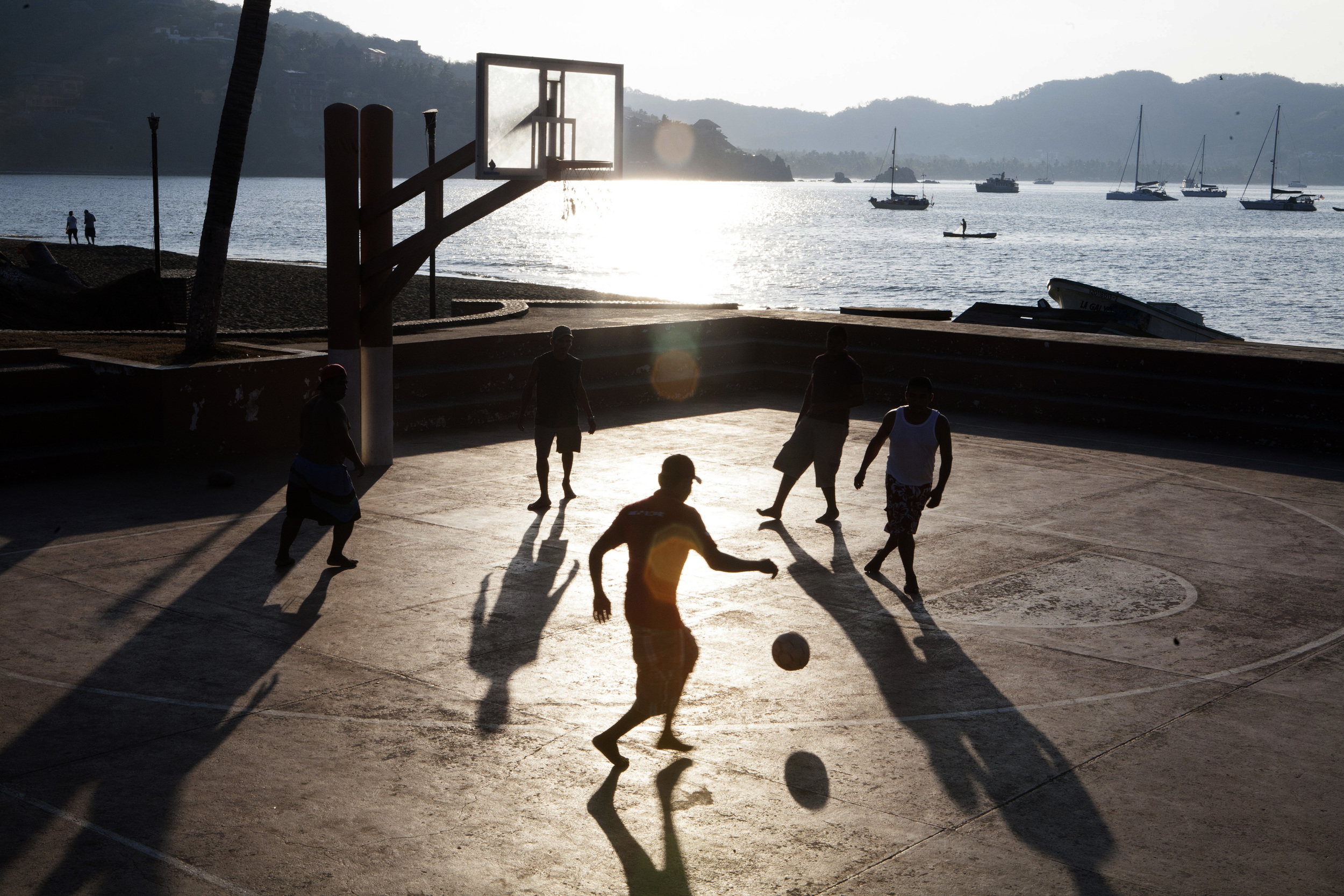  Locals enjoy a game of soccer in the early morning hours at the public basketball court on the waterfront in the main plaza in Zihuatanejo. ©Gail Fisher&nbsp; 