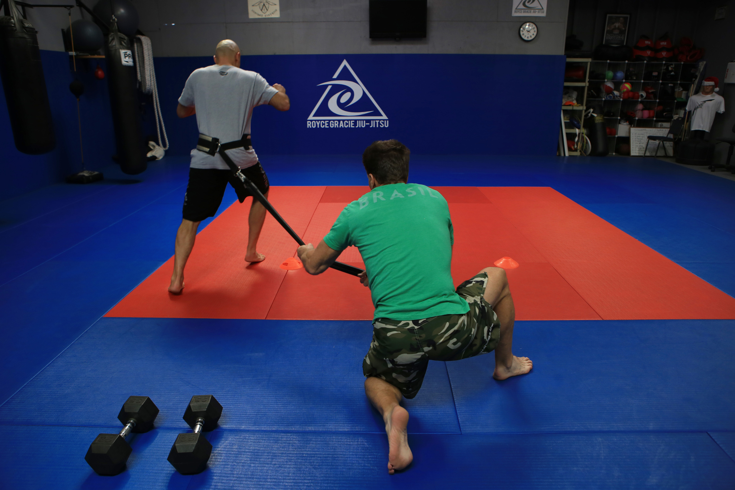  Gracie, left, works on his strength and conditioning with sports trainer, Strom, center, at the Royce Gracie Jiu-Jitsu Academy that he founded to promote mixed martial arts. (©Gail Fisher for ESPN) 