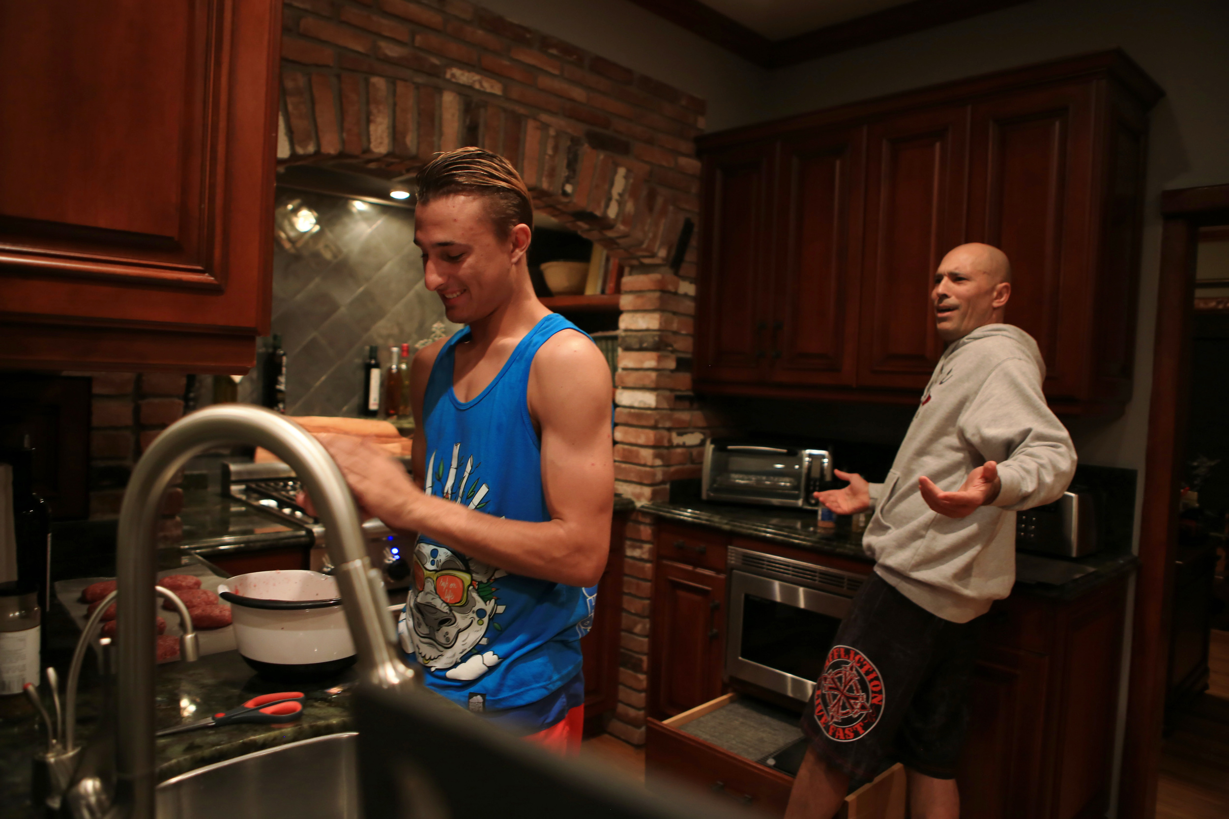  Gracie's son Khor, left, a 17-year-old high school senior, helps his father prepare venison burgers for dinner in the kitchen of their home. The meat was collected from a recent deer hunting trip in Kentucky. (©Gail Fisher for ESPN) 