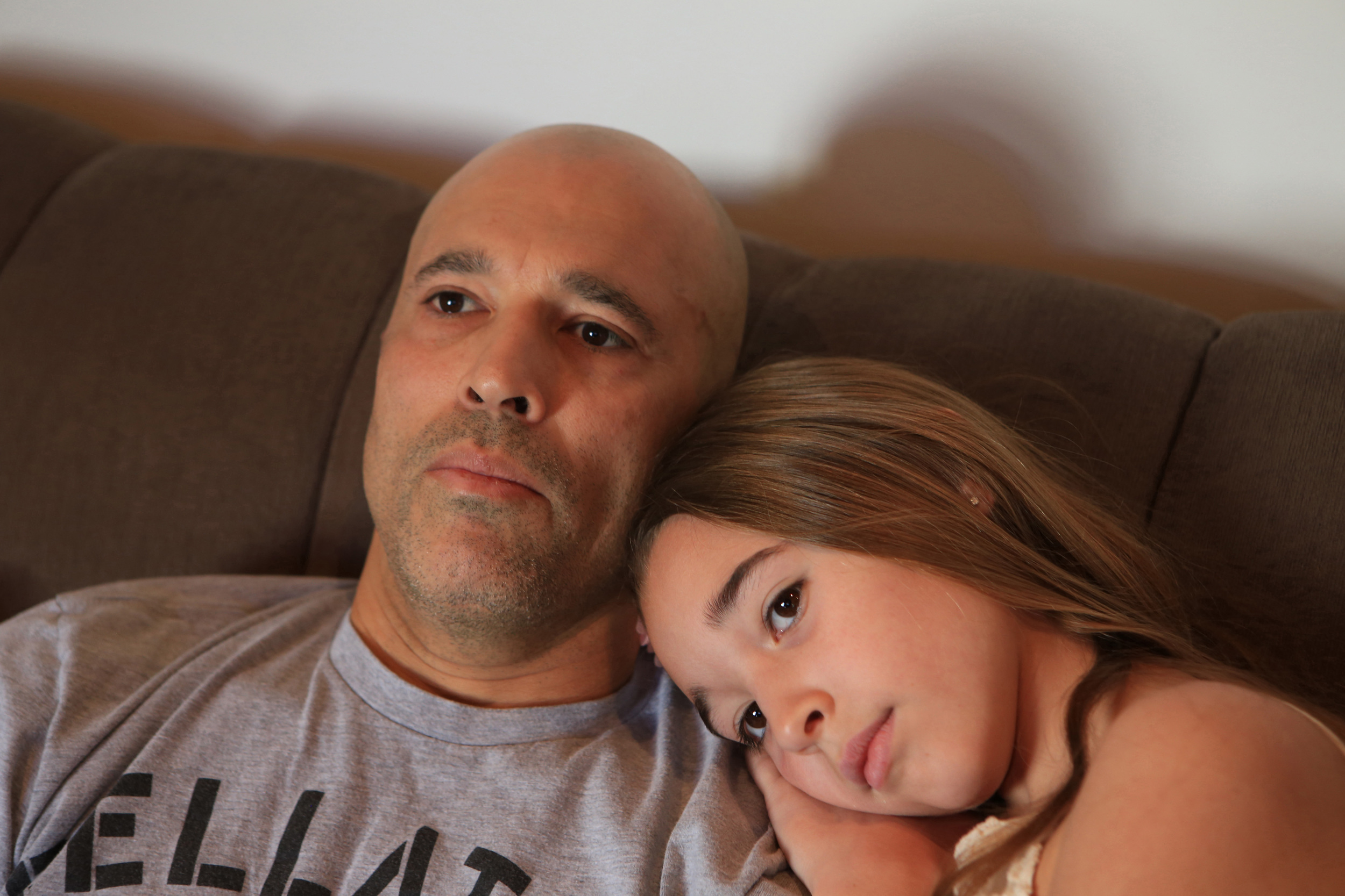  Royce Gracie, father and professional mixed martial artist for Bellator MMA, left, watches early morning television with his 10-year-old daughter, Kharianna, right, after packing her lunch, fixing her breakfast and before taking her to school at the
