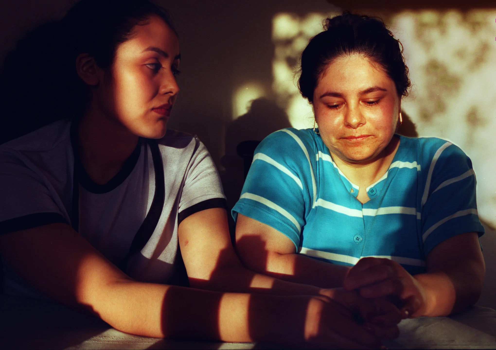 Araceli with her mother, Lupe Almaguer, worries her mother works too hard. Lupe supports the family of five on the $400 to $500 she earns each week cleaning houses in Irvine, Tustin and Newport Beach. Most weeks, she works all seven days. ©Gail Fisher Los Angeles Times 