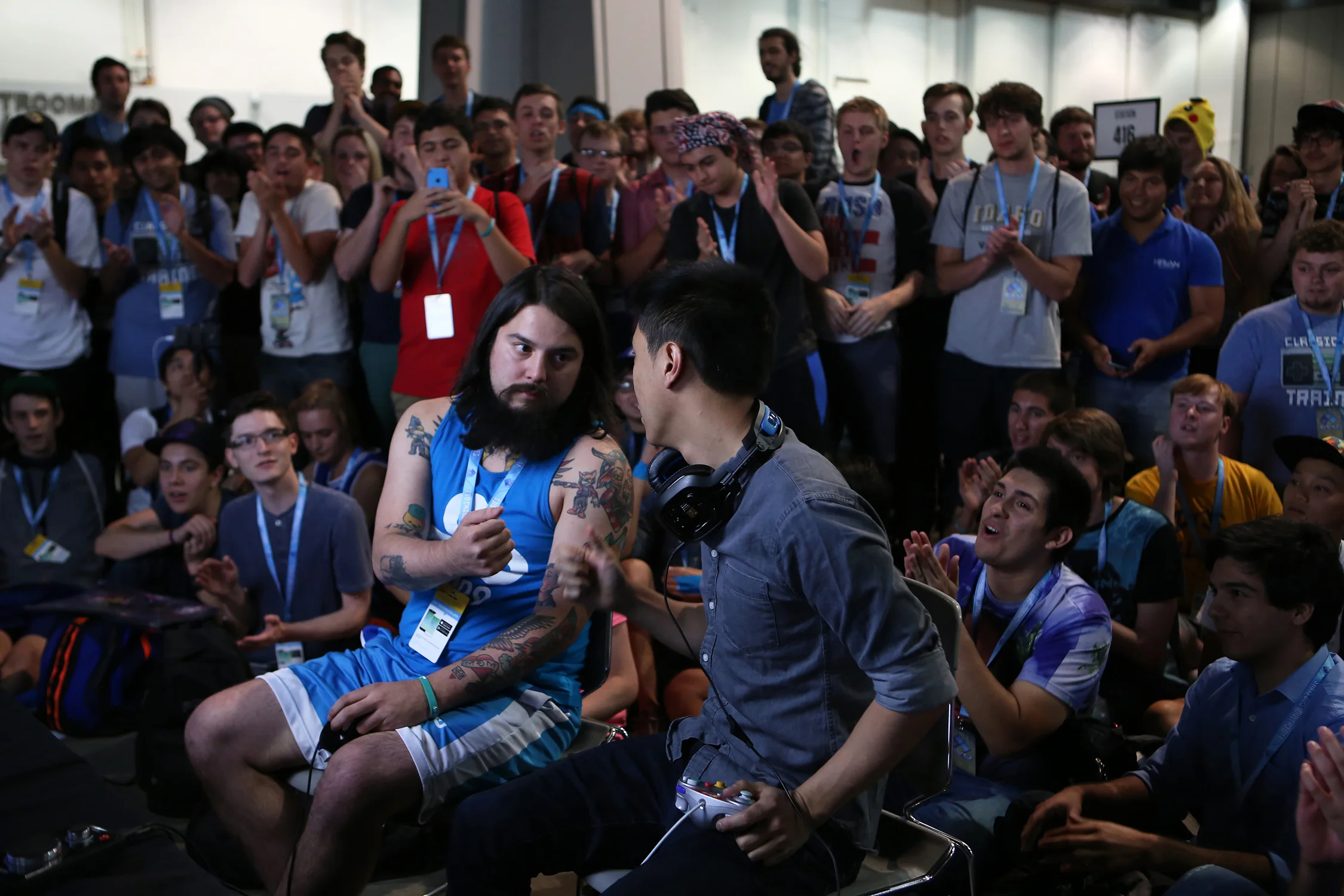 Joseph “MangO” Marquez, left, faces off with Zhu before their match in Smash Bros. Melee in a classic game of rock-paper-scissors to choose the first stage. © Gail Fisher for ESPN