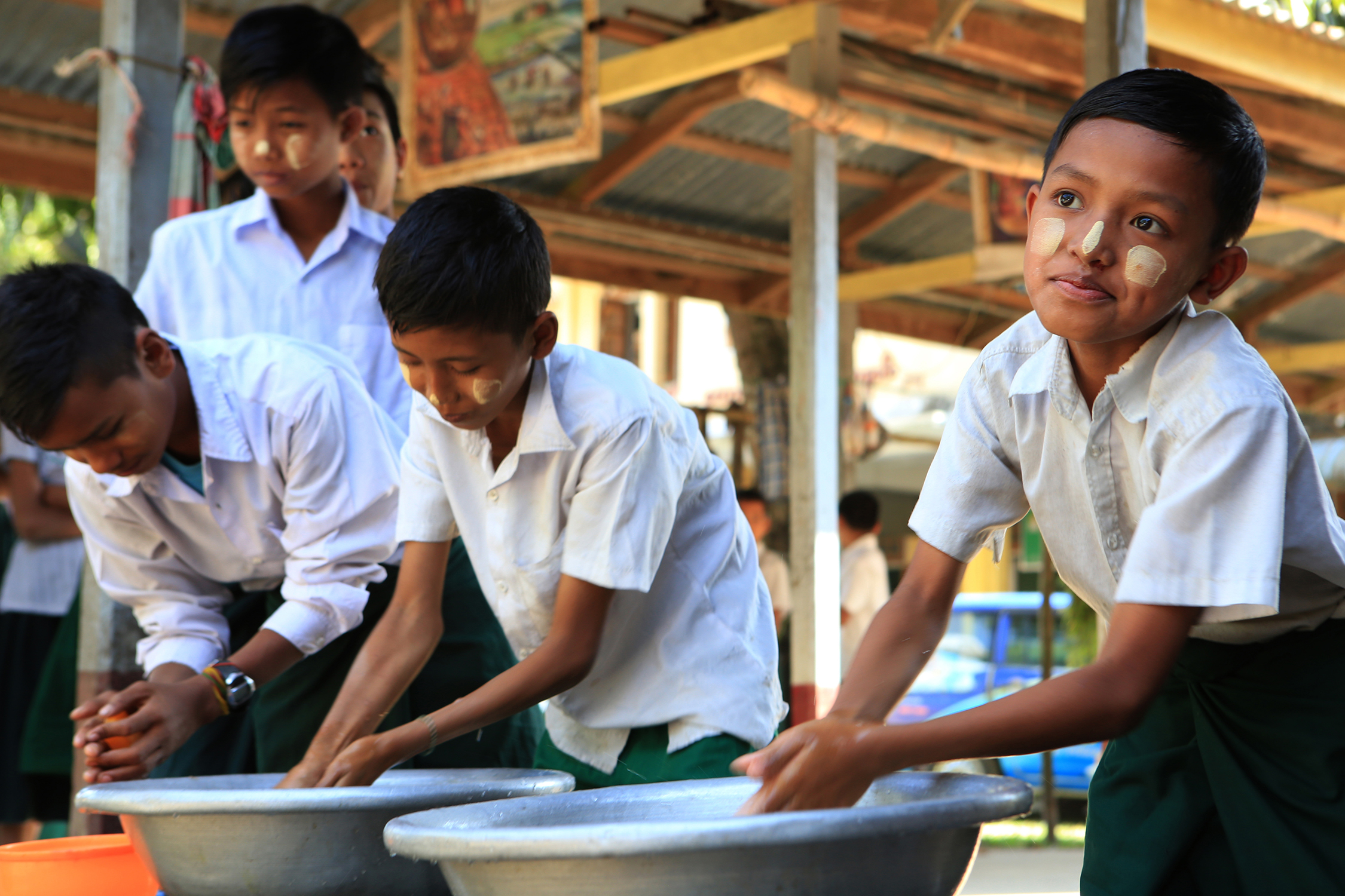  Students line up to wash hands before before a lunch of rice and vegetables. The cost of schooling and meals is subsidized by donors and the government of Myanmar. © Gail Fisher for Los Angeles Times 