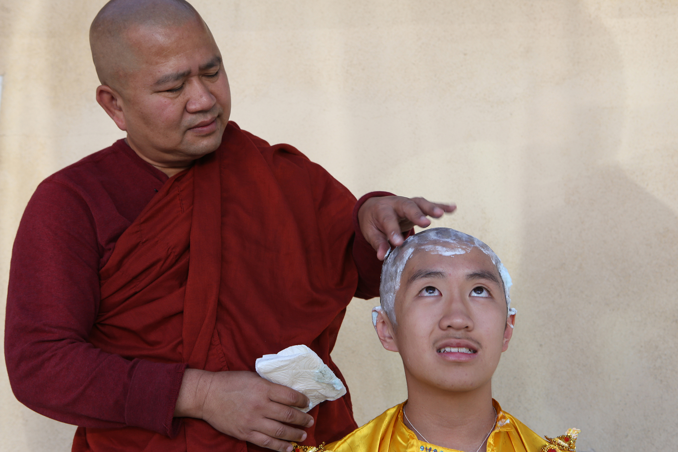  Buddhist monk Ashin Gunissara shaves the head of Filbert Win Min Aung, freshman at Arcadia High School, as the 13-year-old begins his three day stay at the Dhammajoti Meditation Center in Baldwin Park. © Gail Fisher for Los Angeles Times    