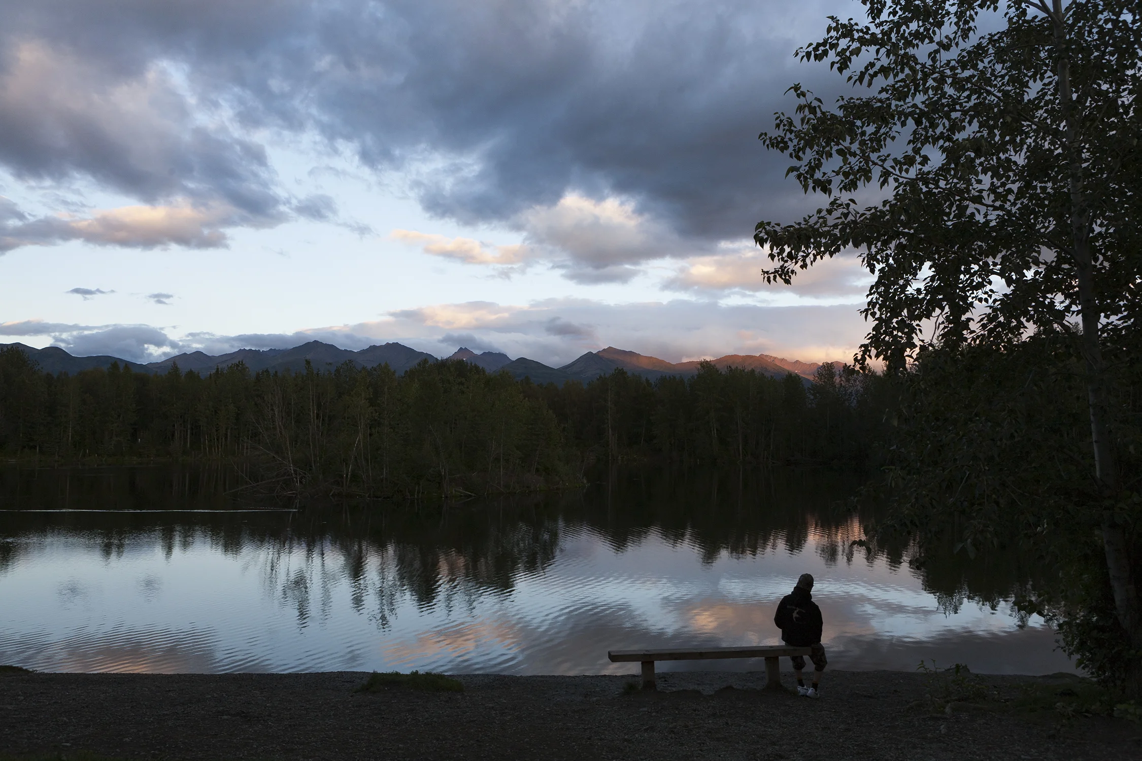 Sun sets over University Lake in Anchorage, Alaska, nestled at the base of the Chugach Mountain Range. © Photo by Gail Fisher