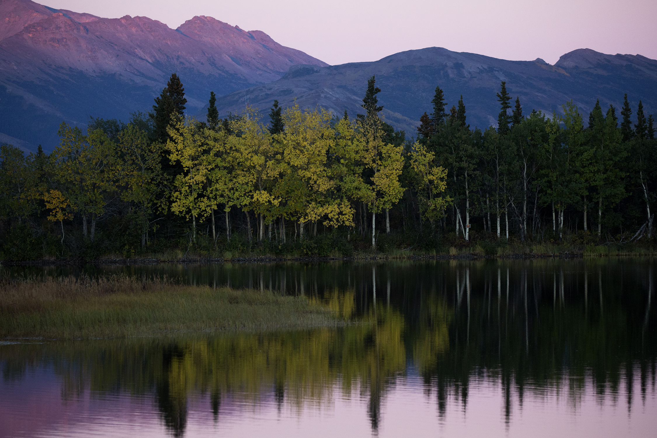  Sun sets over tranquil Otto Lake with views of Mt. Healy and Mt. Dora ten miles north of north of Denali National Park and Preserve. Photo by Gail Fisher 