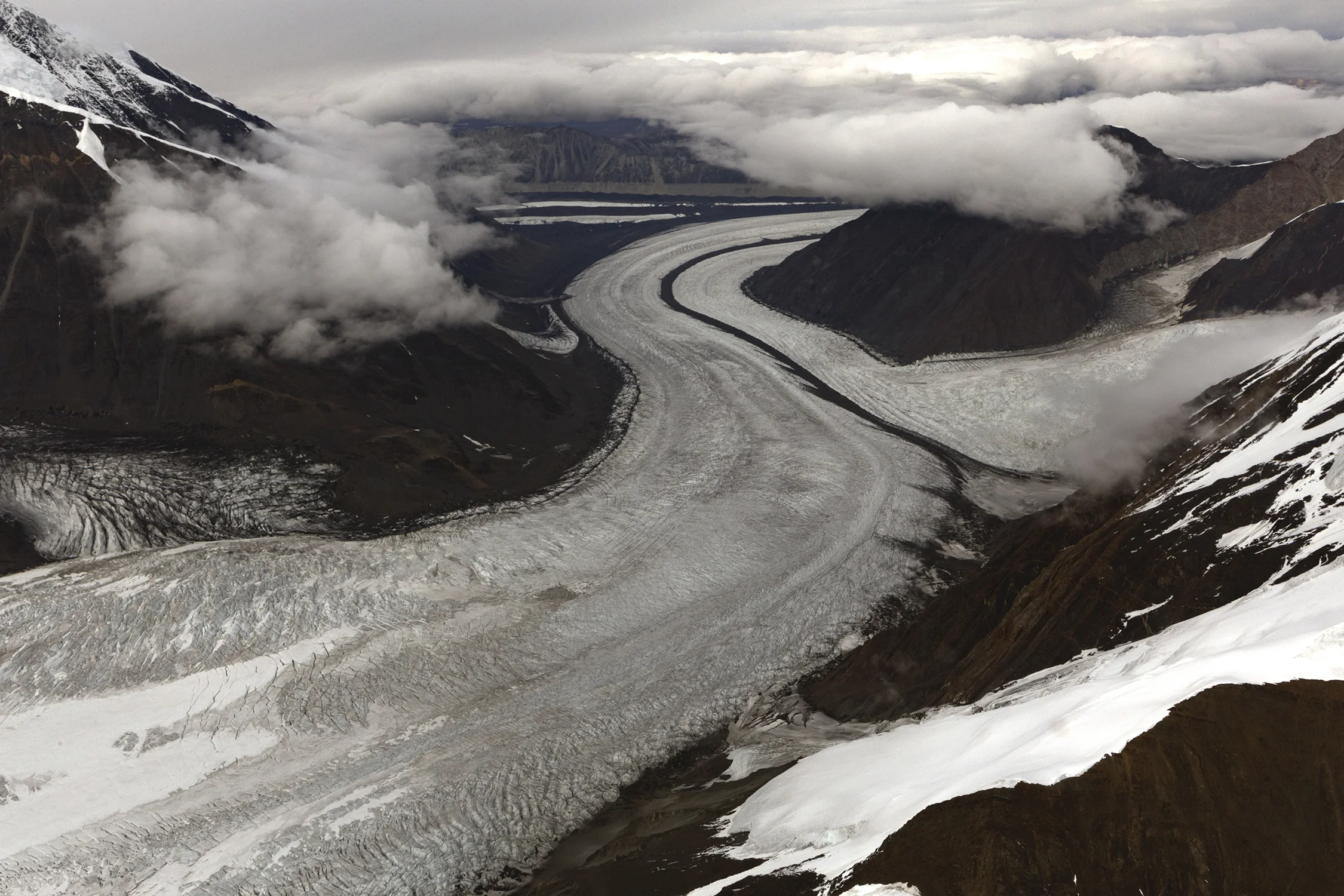 Ruth Glacier and medial moraines, dark stripes of rock debris flowing down the middle. © Photo by Gail Fisher