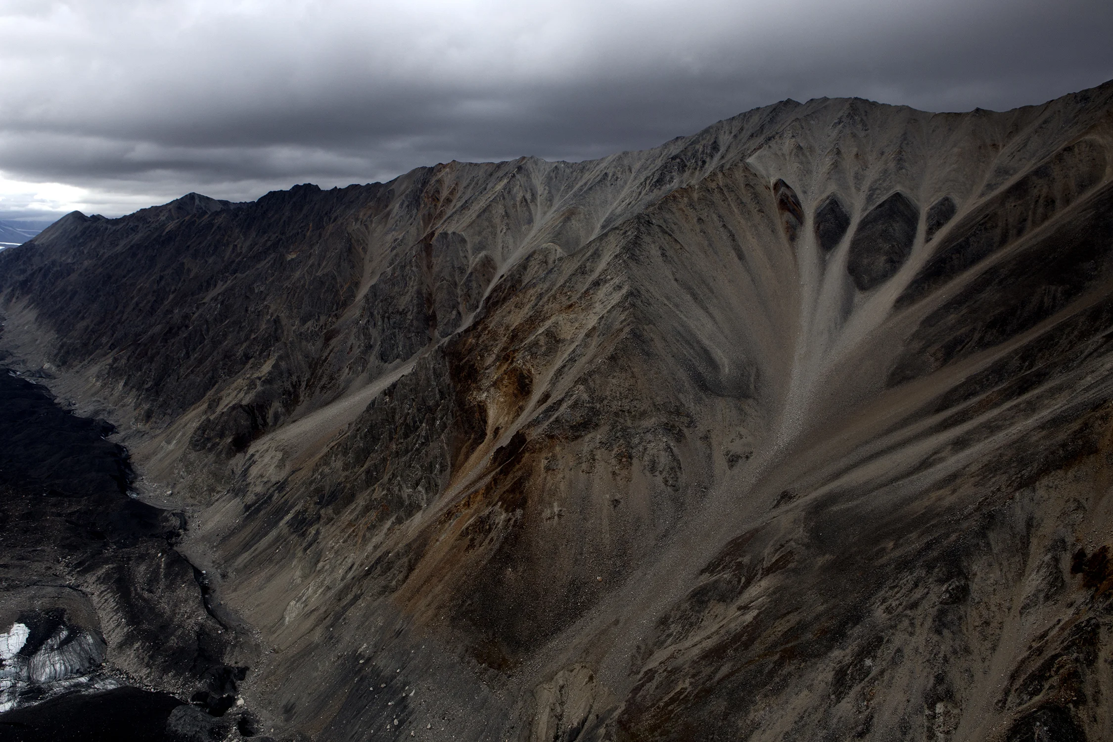  The Polychrome consists of five glaciers in the Alaska Range of Denali National Park and Preserve which have been affected by the processes of regional metamorphose, folding and faulting to form rocks such as schist, quartzite, phyllite, late, marble and limestone. © Photo by Gail Fisher