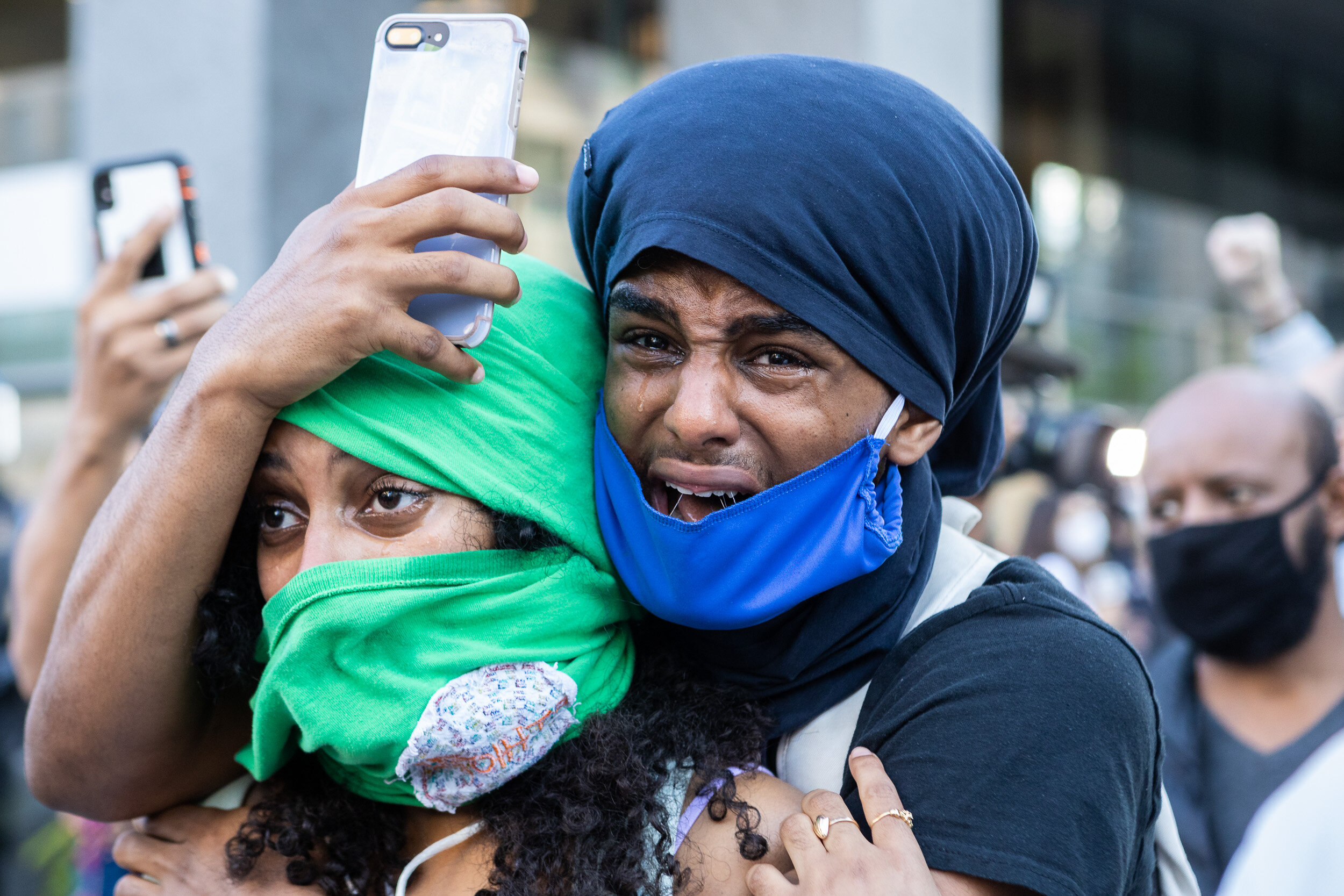  A man weeps and embraces a companion after witnessing the arrest of a fellow protester shortly after Washington, D.C.’s 7 p.m. curfew during mass demonstrations in reaction to the death of George Floyd June 1, 2020. 