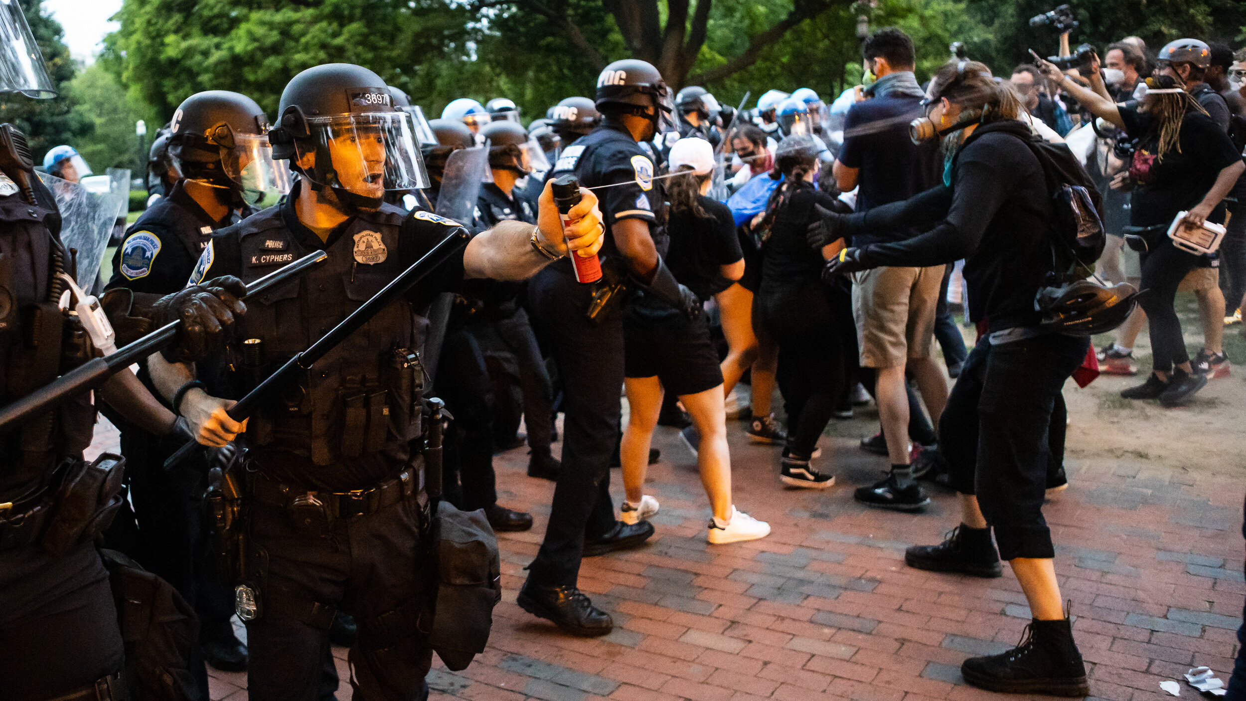  A Washington Metropolitan Police Department officer pepper sprays protesters in Lafayette Square near the White House June 22, 2020. 