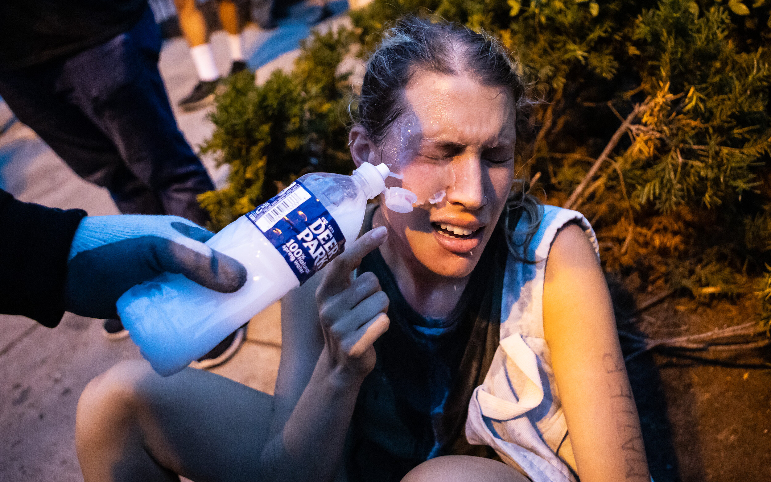  A protester has her face washed off by another protester after being pepper sprayed by police in Lafayette Square near the White House June 22, 2020. 