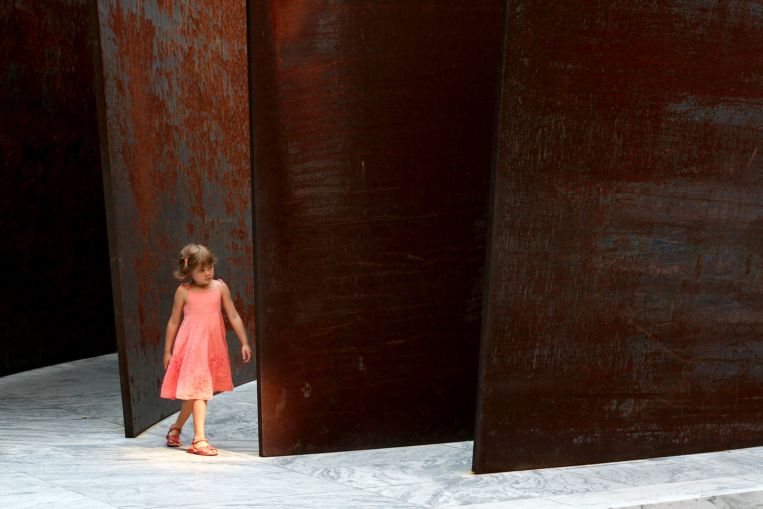  A girl explores a Richard Serra sculpture at the Museum of Modern Art, New York, July 9, 2007. 