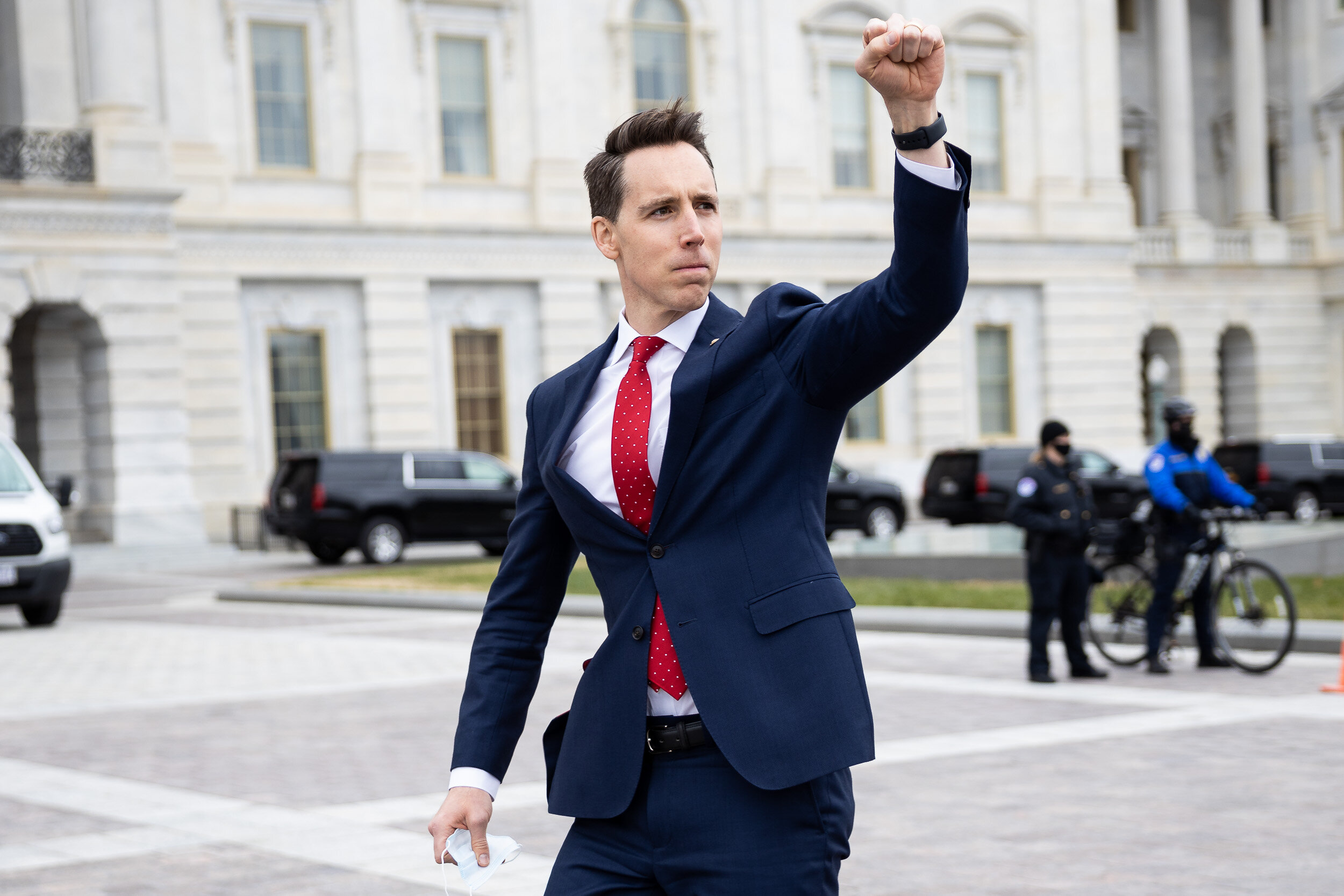  Sen. Josh Hawley (R-Mo.) gestures in solidarity toward a crowd of Trump supporters gathered outside the U.S. Capitol to protest the certification of President-elect Joe Biden’s electoral-college victory Jan. 6, 2021. Soon thereafter, a violent mob s