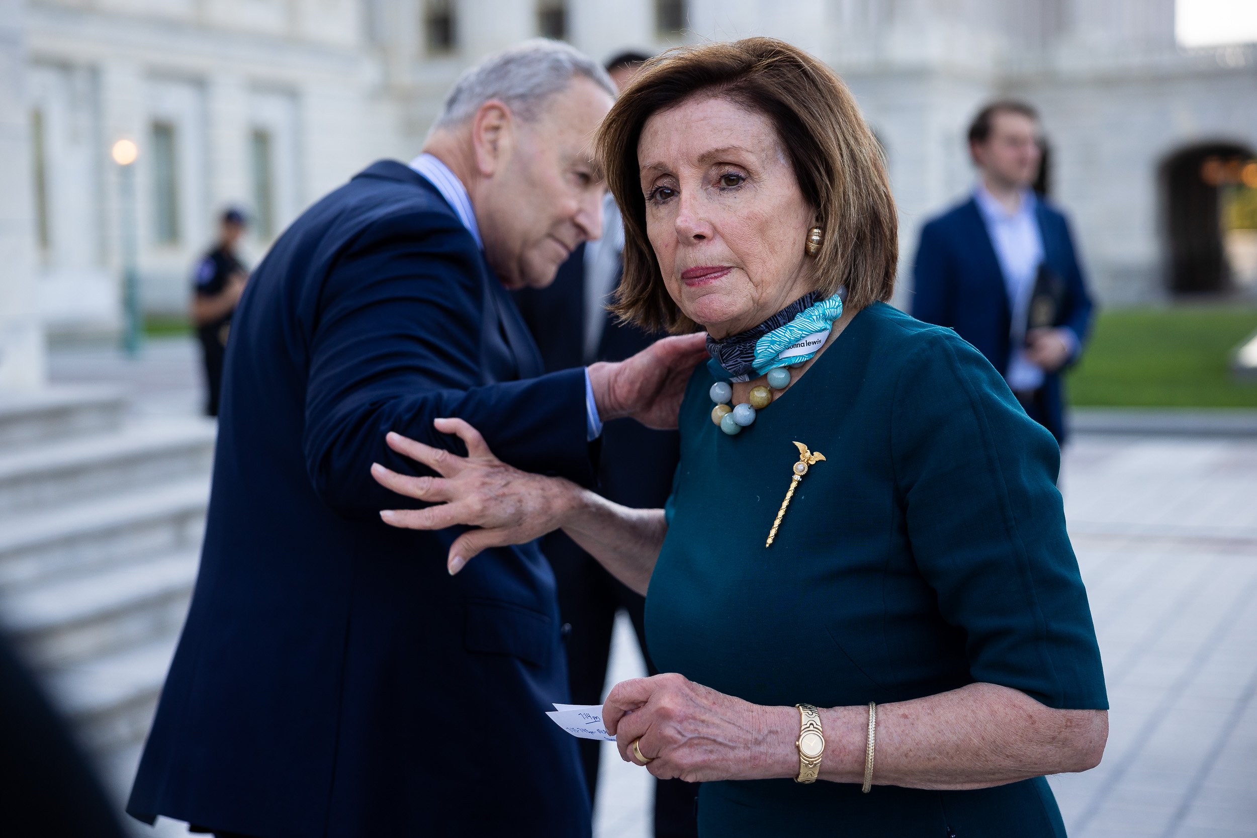  House Speaker Nancy Pelosi (D-Calif.) and Senate Majority Leader Chuck Schumer (D-N.Y.) part ways after a ceremony commemorating 600,000 American lives lost to COVID-19 outside the U.S. Capitol June 14, 2021. 