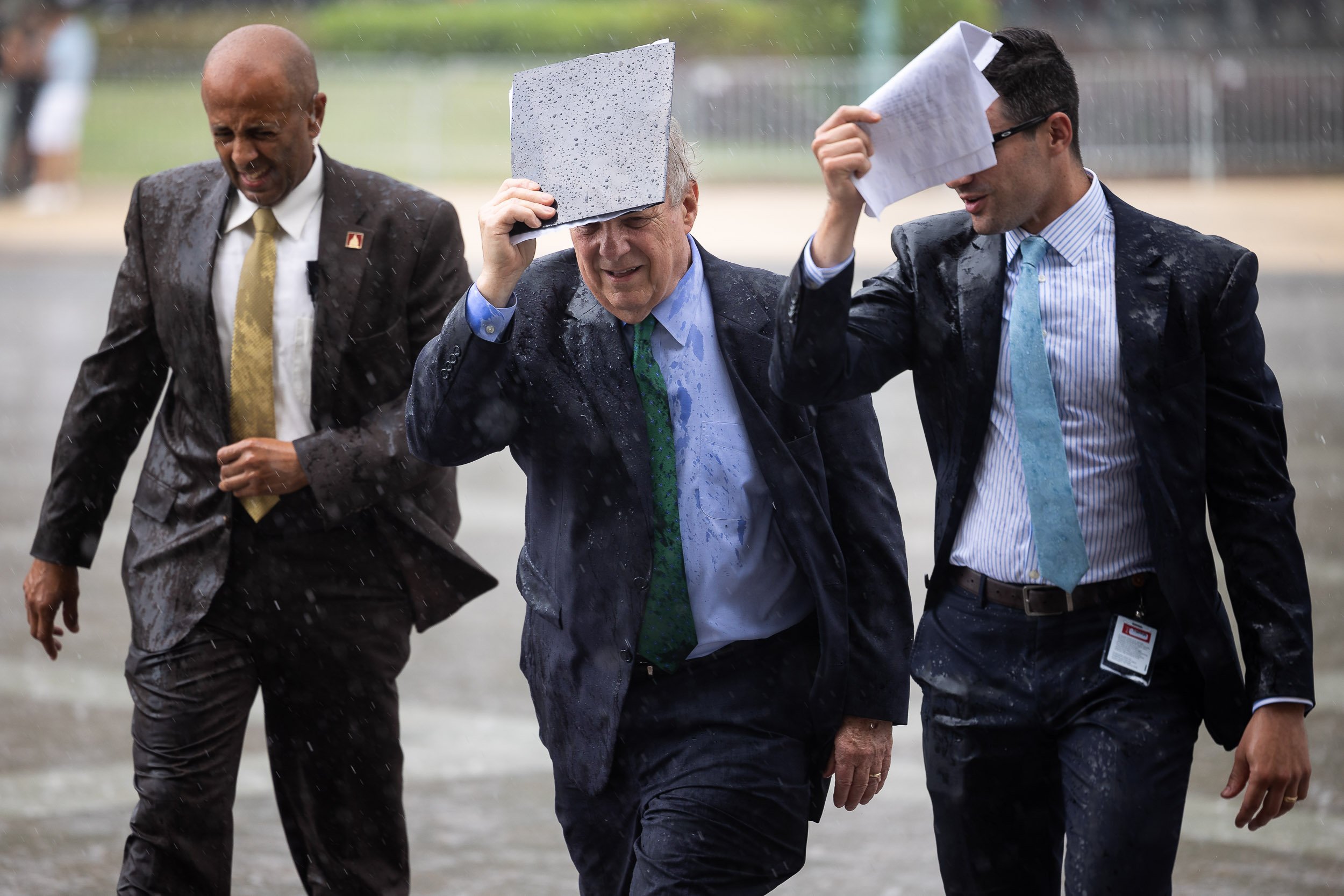  Senate Majority Whip Dick Durbin (D-Ill.) gets caught in a rain storm on Capitol Hill July 21, 2021. 