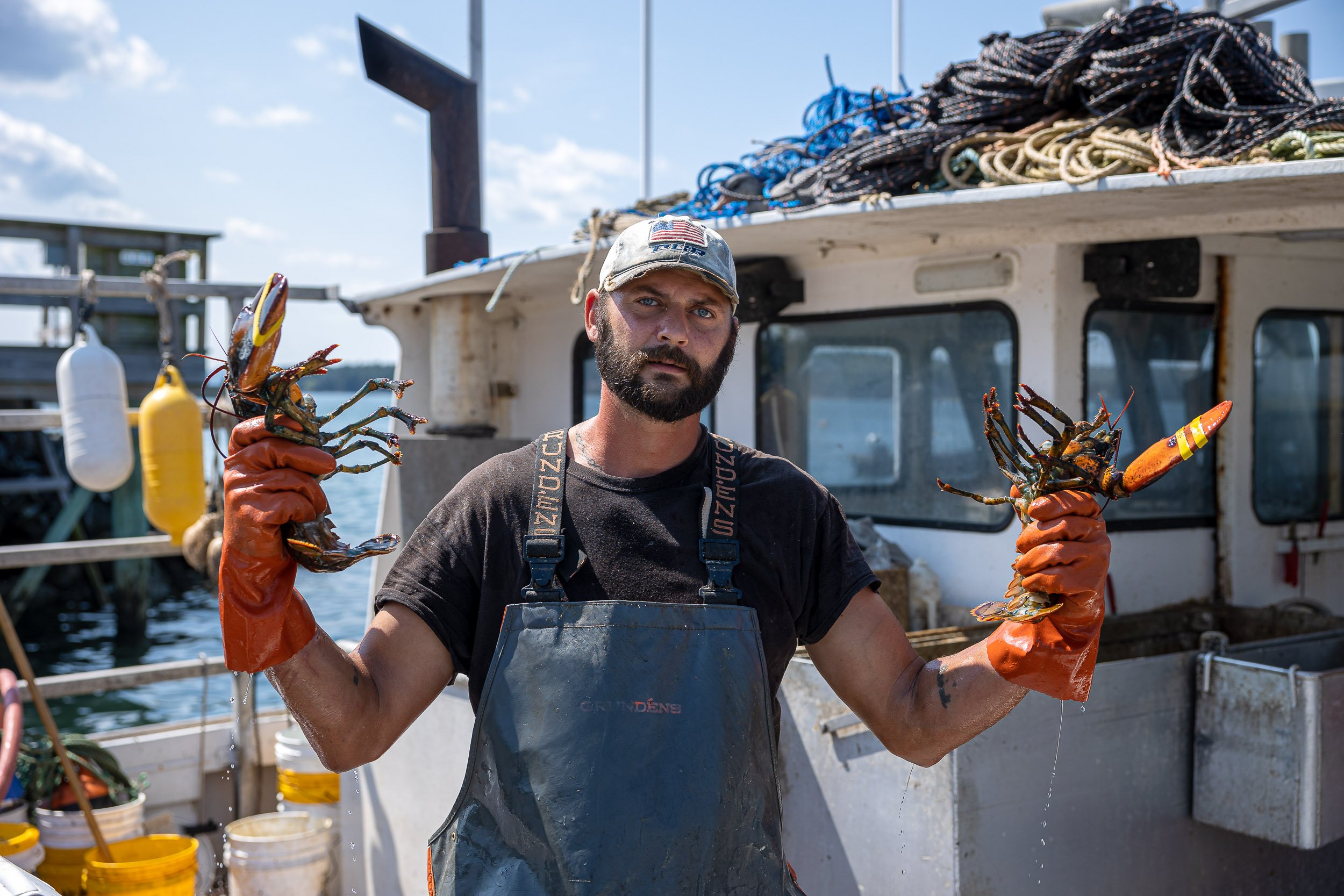  Lobster-boat sternman Jeremy White shows off part of the day’s catch while docked in South Gouldsboro, Maine Aug. 27, 2021. 