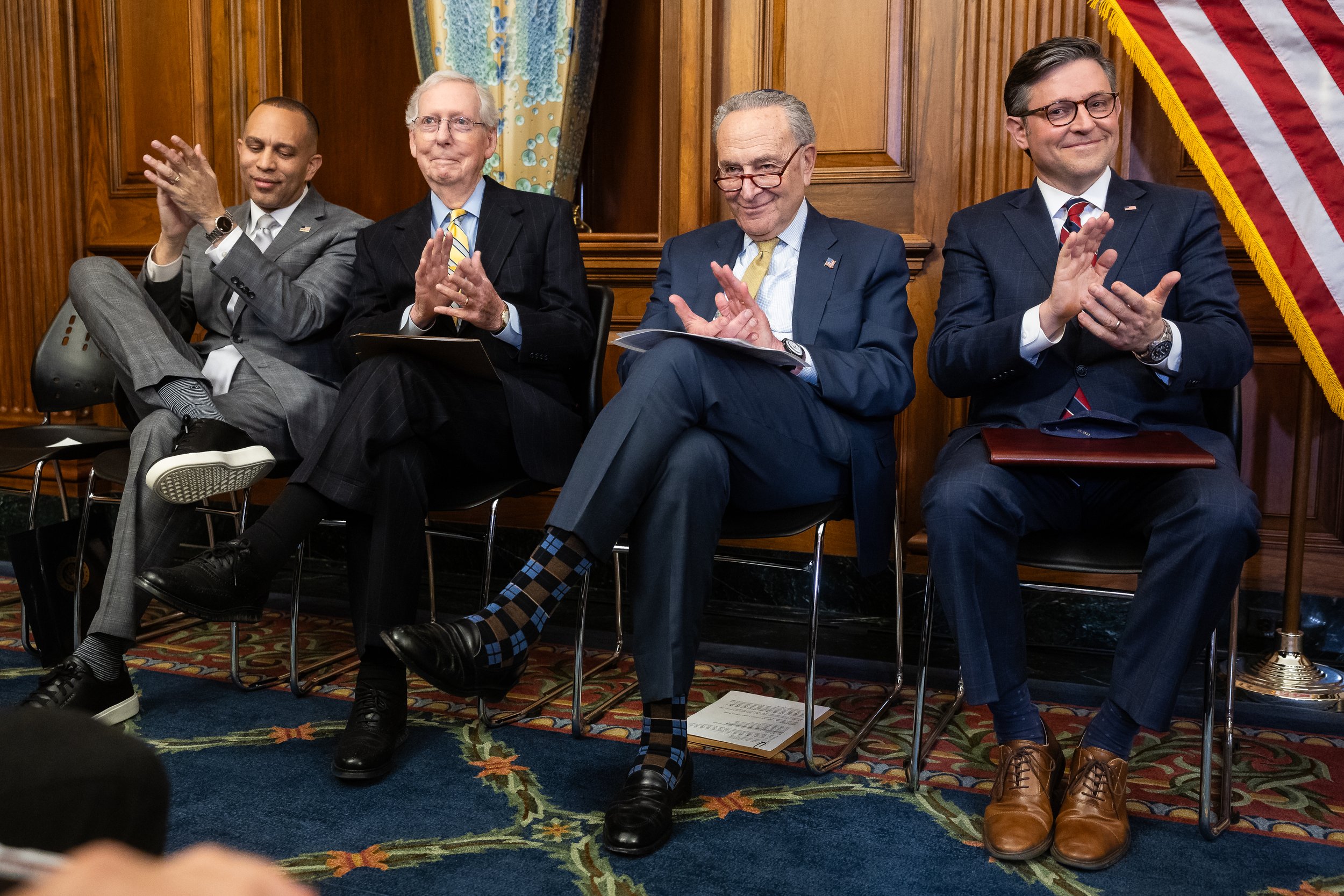 From left, House Minority Leader Hakeem Jeffries (D-N.Y.), Senate Minority Leader Mitch McConnell (R-Ky.), Senate Majority Leader Chuck Schumer (D-N.Y.), and House Speaker Mike Johnson (R-La.) applaud during the lighting of the Capitol Menorah at th