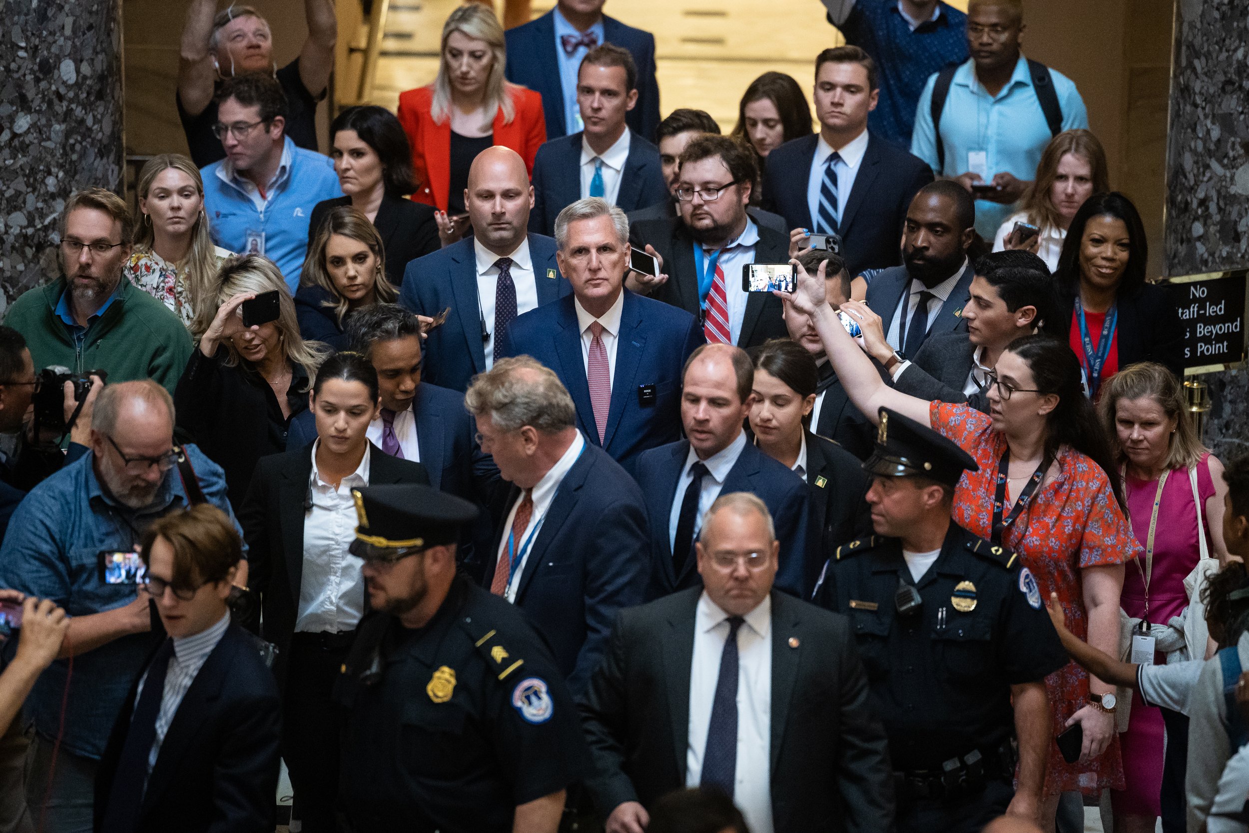  House Speaker Kevin McCarthy (R-Calif.) is swarmed by journalists as he departs the House chamber May 30, 2023. 