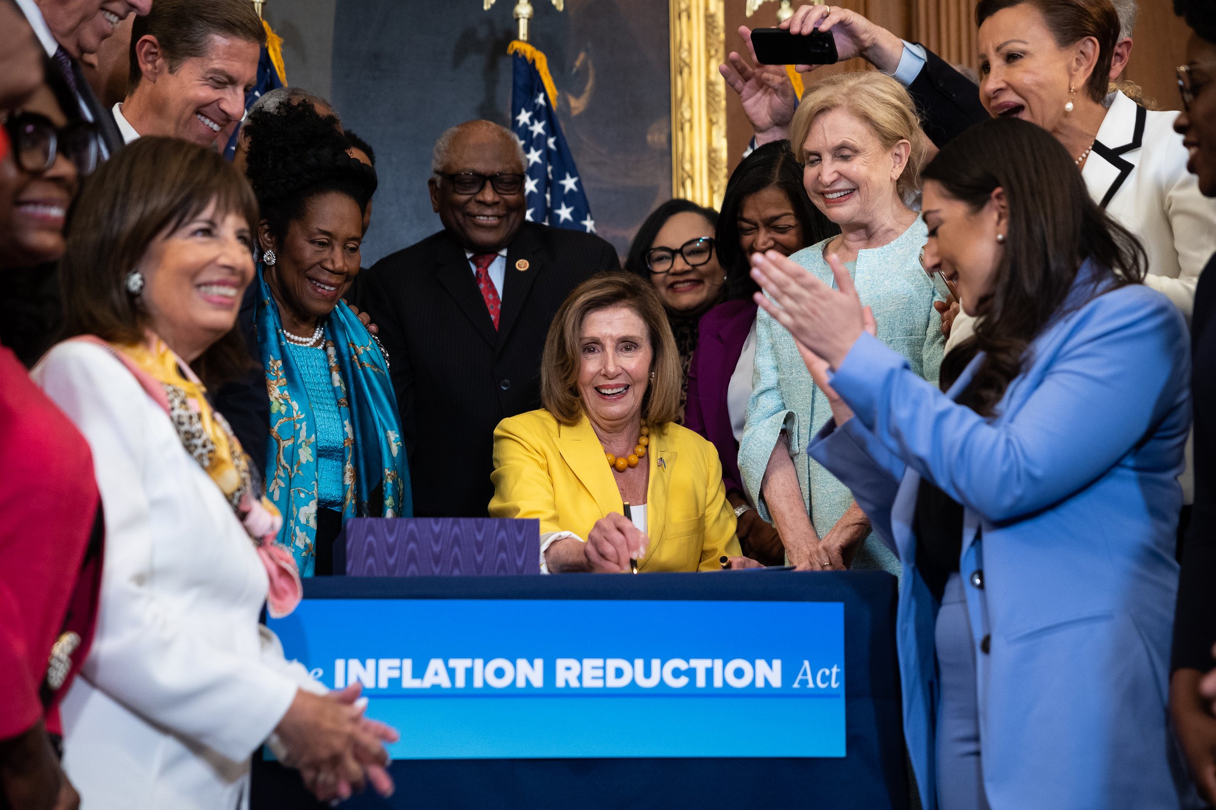  House Speaker Nancy Pelosi (D-Calif.), surrounded by other House Democrats, signs the Inflation Reduction Act at the U.S. Capitol Aug. 12, 2022. 